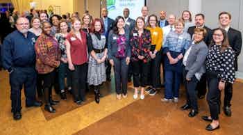 A large group of AMLI employees celebrating their apartment buildings participation in the Atlanta Better Buildings Challenge