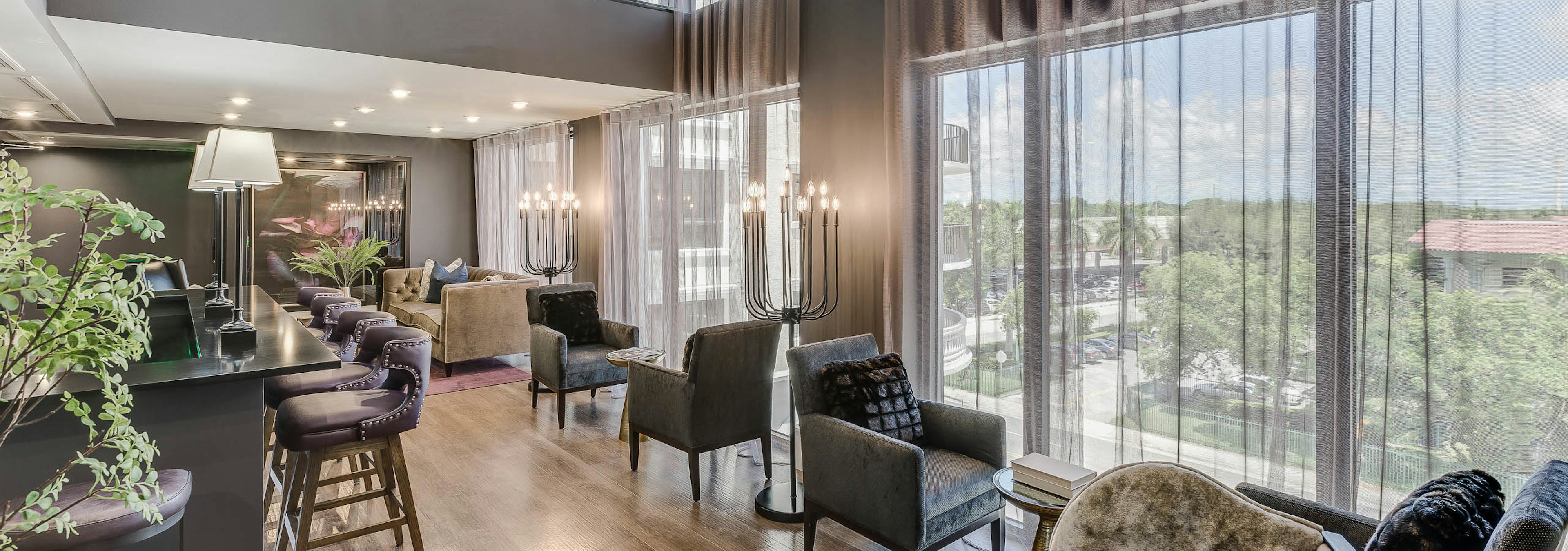 Second floor interior view of the AMLI Joya two story resident lounge with modern furnishings and floor to ceiling windows 