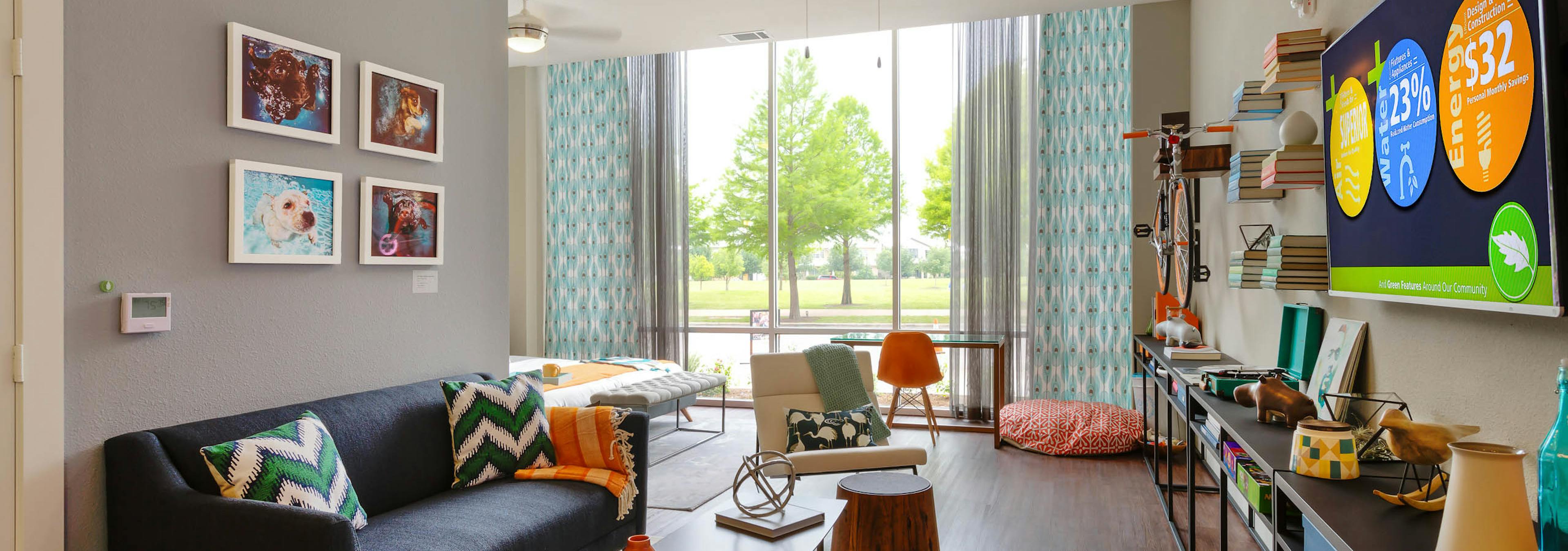 Close up of AMLI at Mueller living room with chevron throw pillows and curtains and grey walls with dark flooring