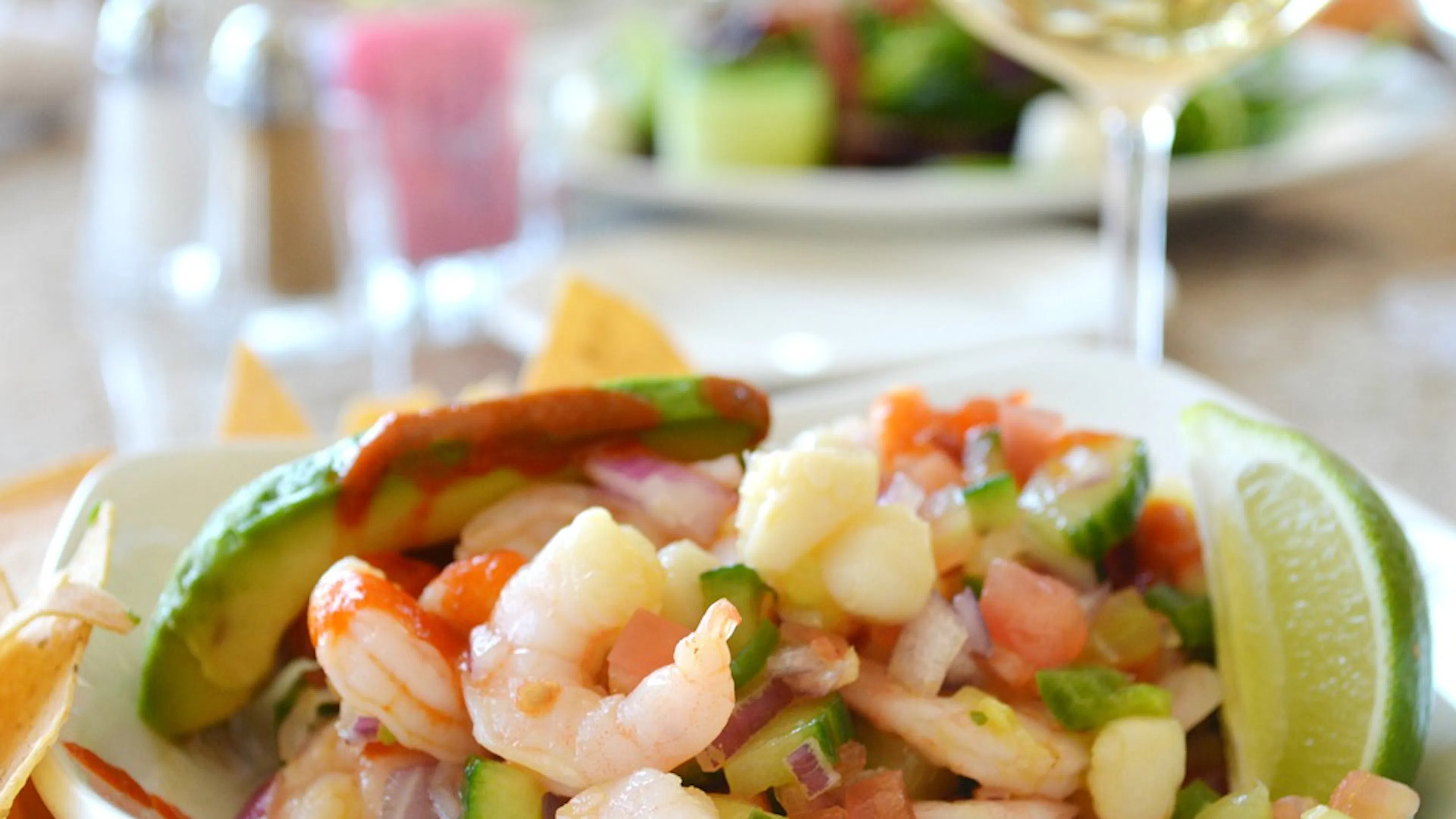 Close up of a bowl of ceviche with lime and tomatoes