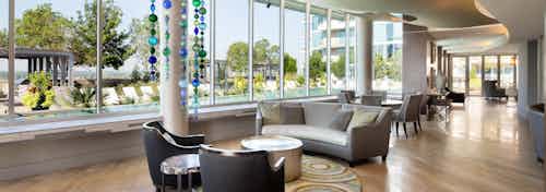 Interior view of sky lounge at AMLI Design District apartment building with various seating areas and view of pool deck