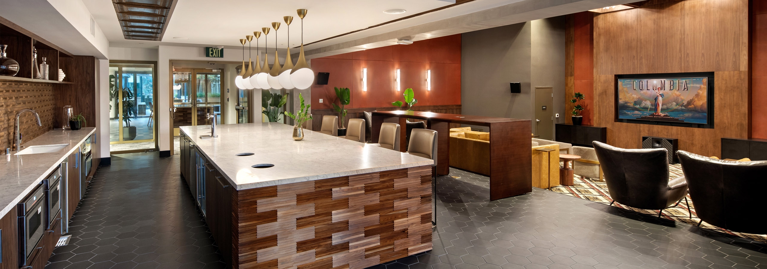Daytime view of theatre kitchen with decorative ceiling and wooden side paneling and ornate lighting at AMLI Old Pasadena