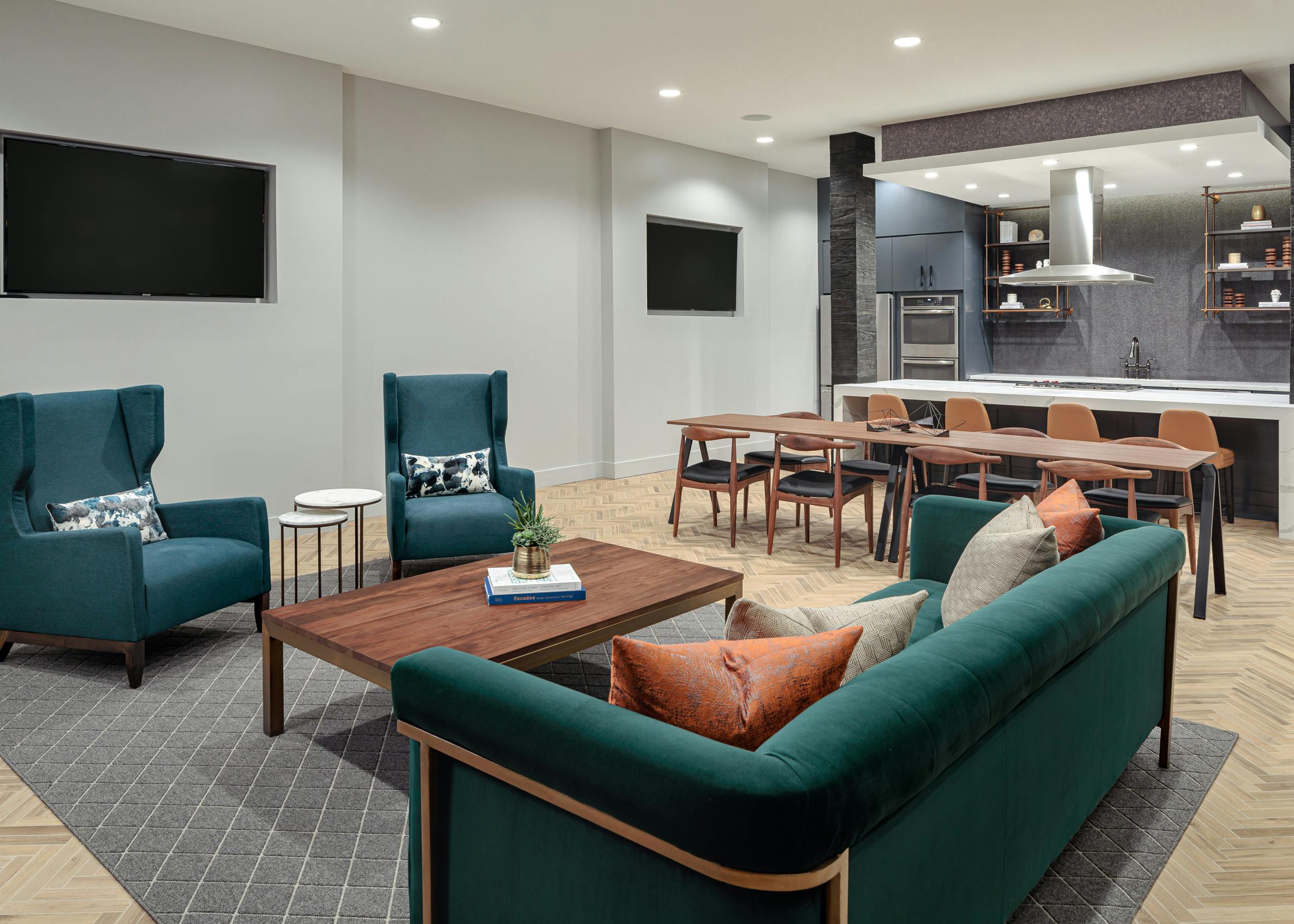 Close up of seating area in the tap room at AMLI Addison with light flooring and two flat screen TVs on the walls