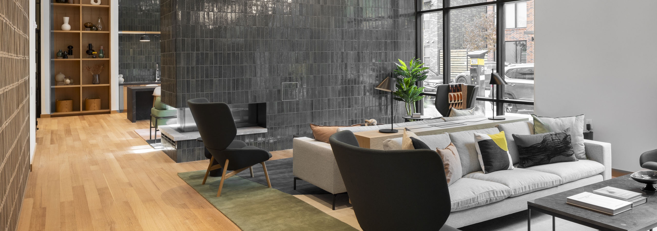 Coworking space at AMLI Branch Park apartments with lounge seating and a floor to ceiling green tiled fireplace