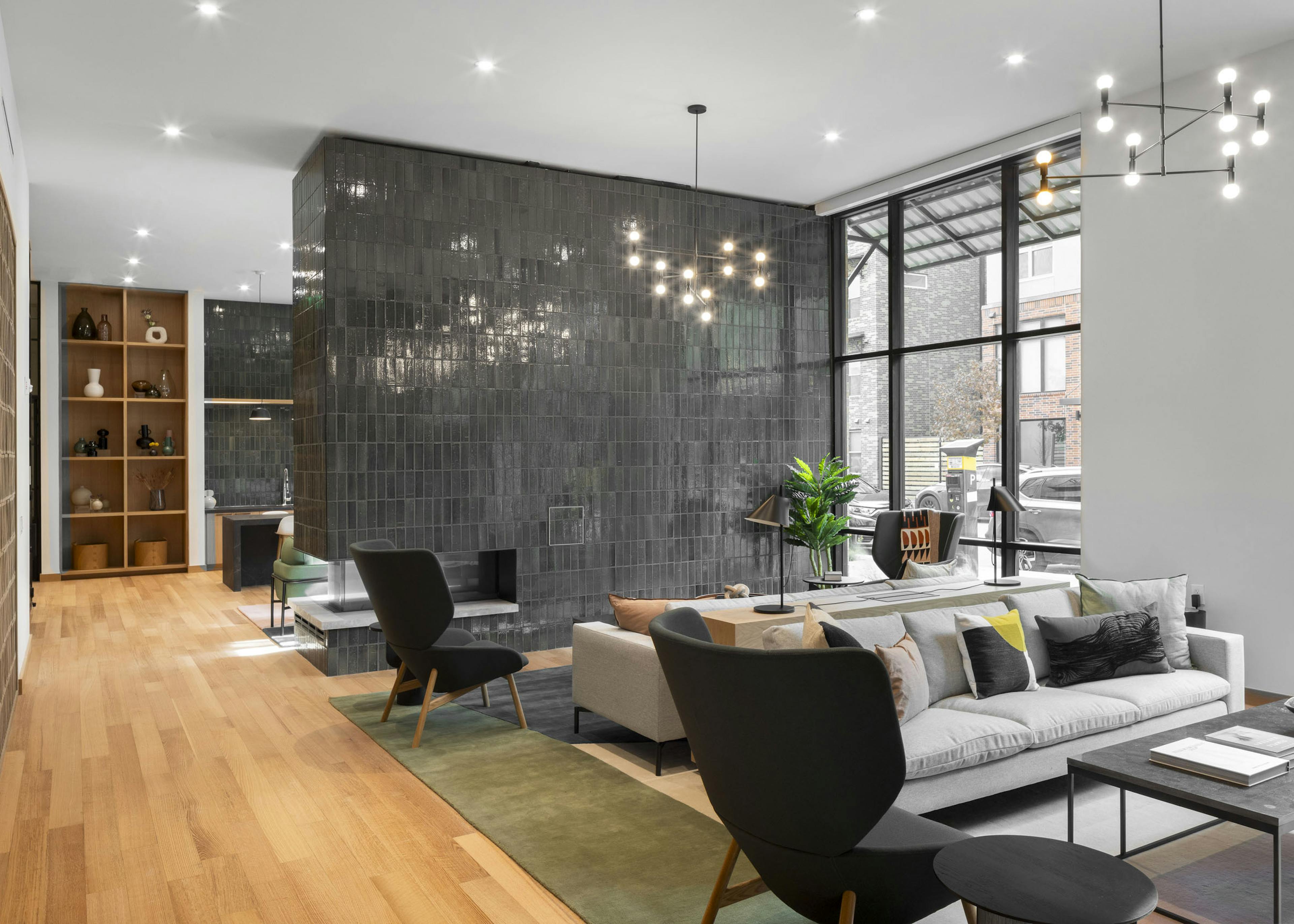 Coworking space at AMLI Branch Park apartments with lounge seating and a floor to ceiling green tiled fireplace