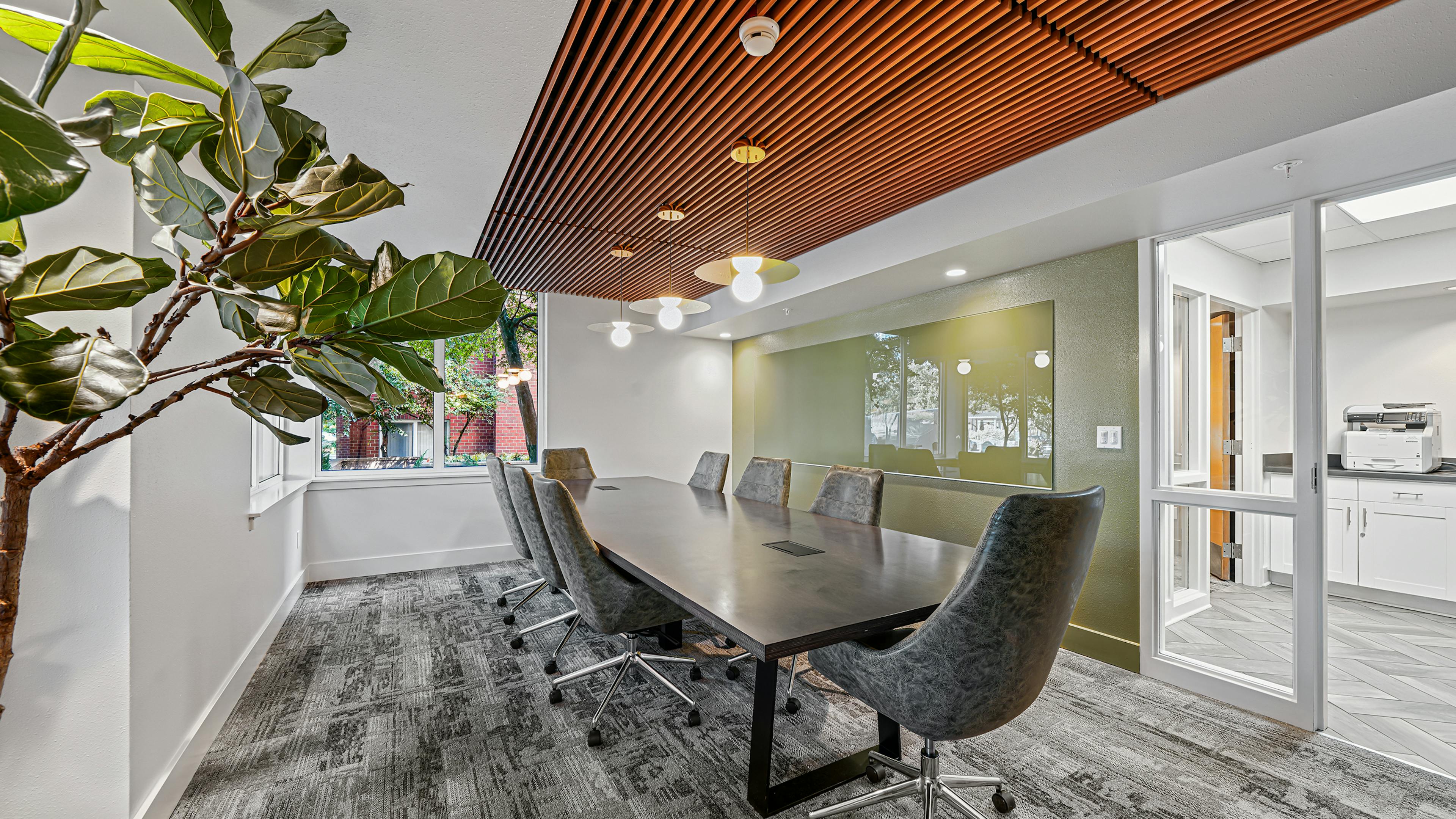 AMLI Bellevue Park conference room with wood paneled ceiling over large conference table surrounded by eight gray chairs
