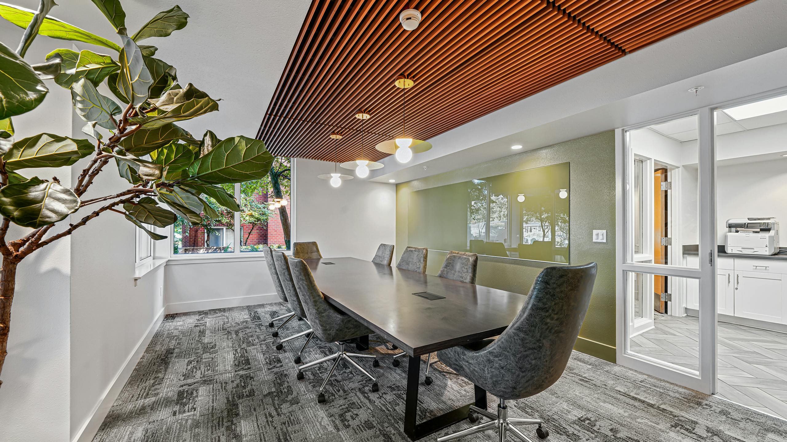 AMLI Bellevue Park conference room with wood paneled ceiling over large conference table surrounded by eight gray chairs