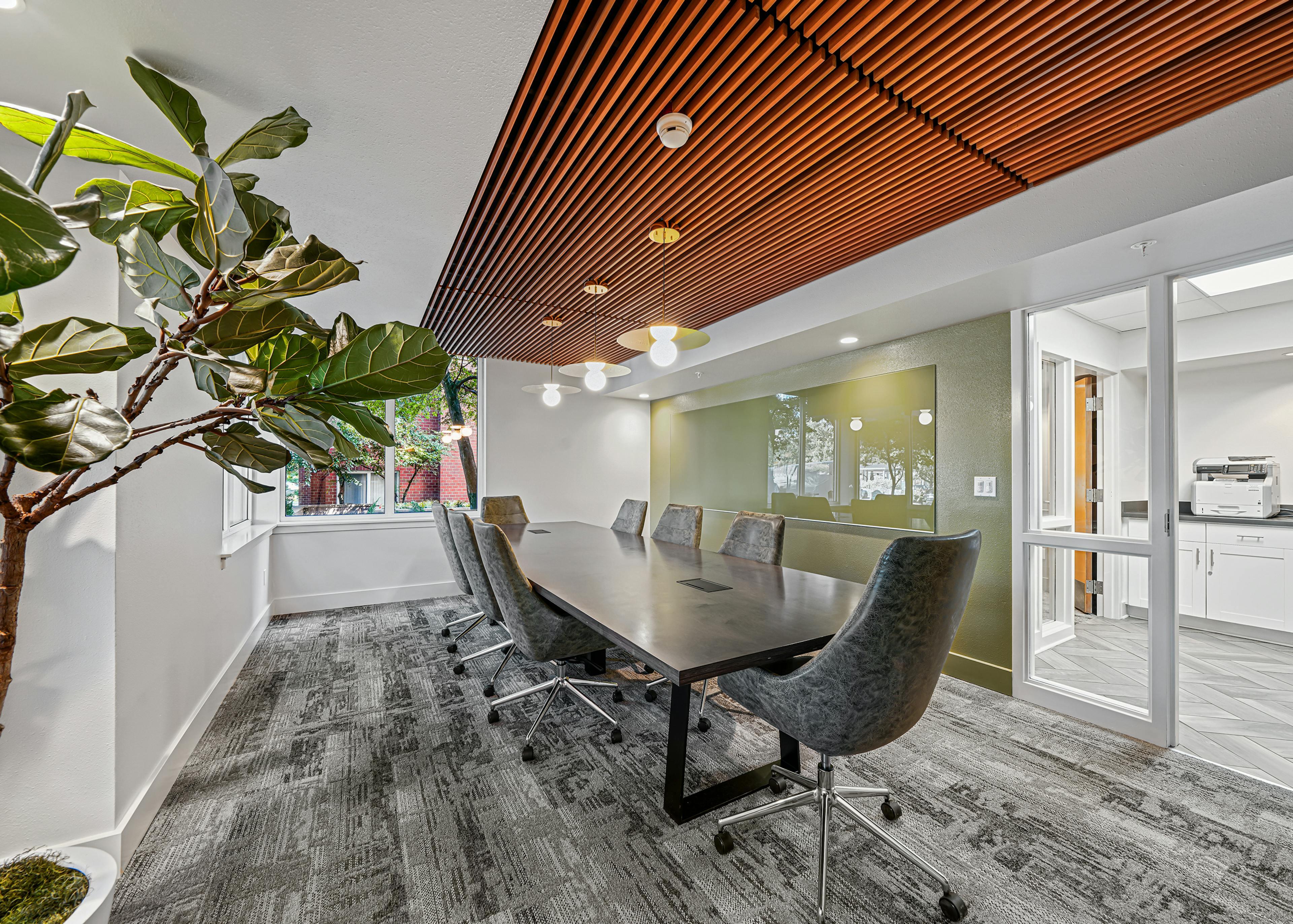 AMLI Bellevue Park conference room with wood paneled ceiling over large conference table surrounded by eight gray chairs