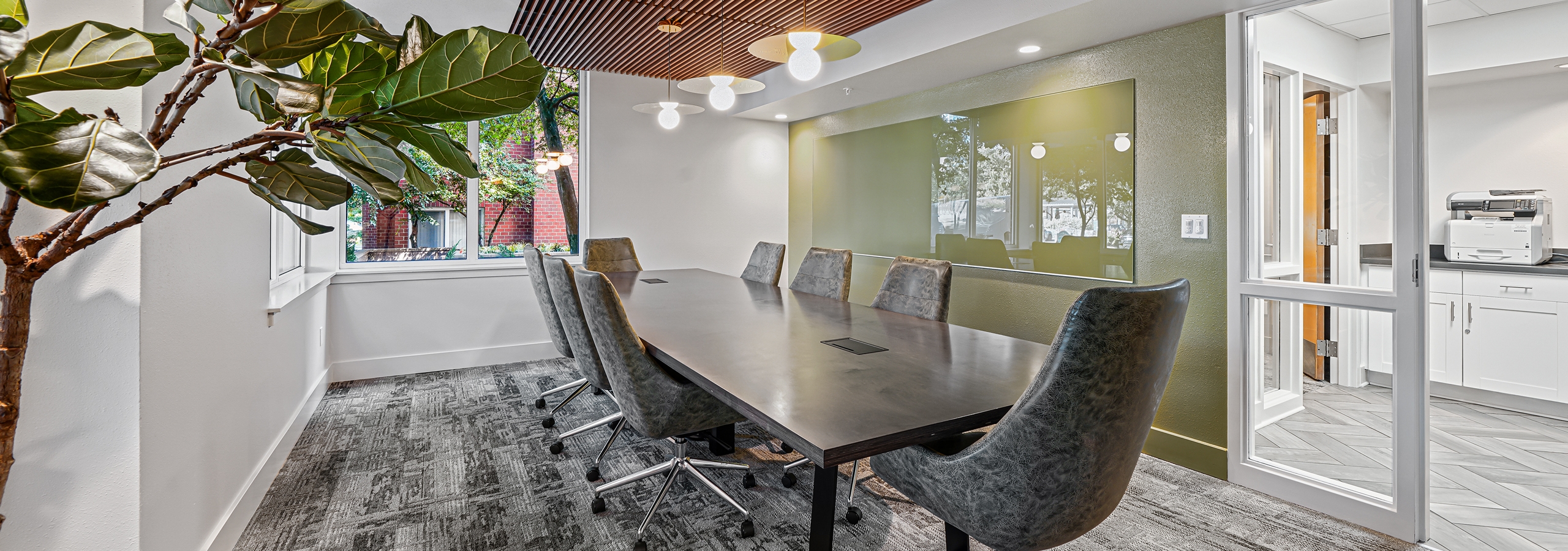 AMLI Bellevue Park conference room with wood paneled ceiling over large conference table surrounded by eight gray chairs