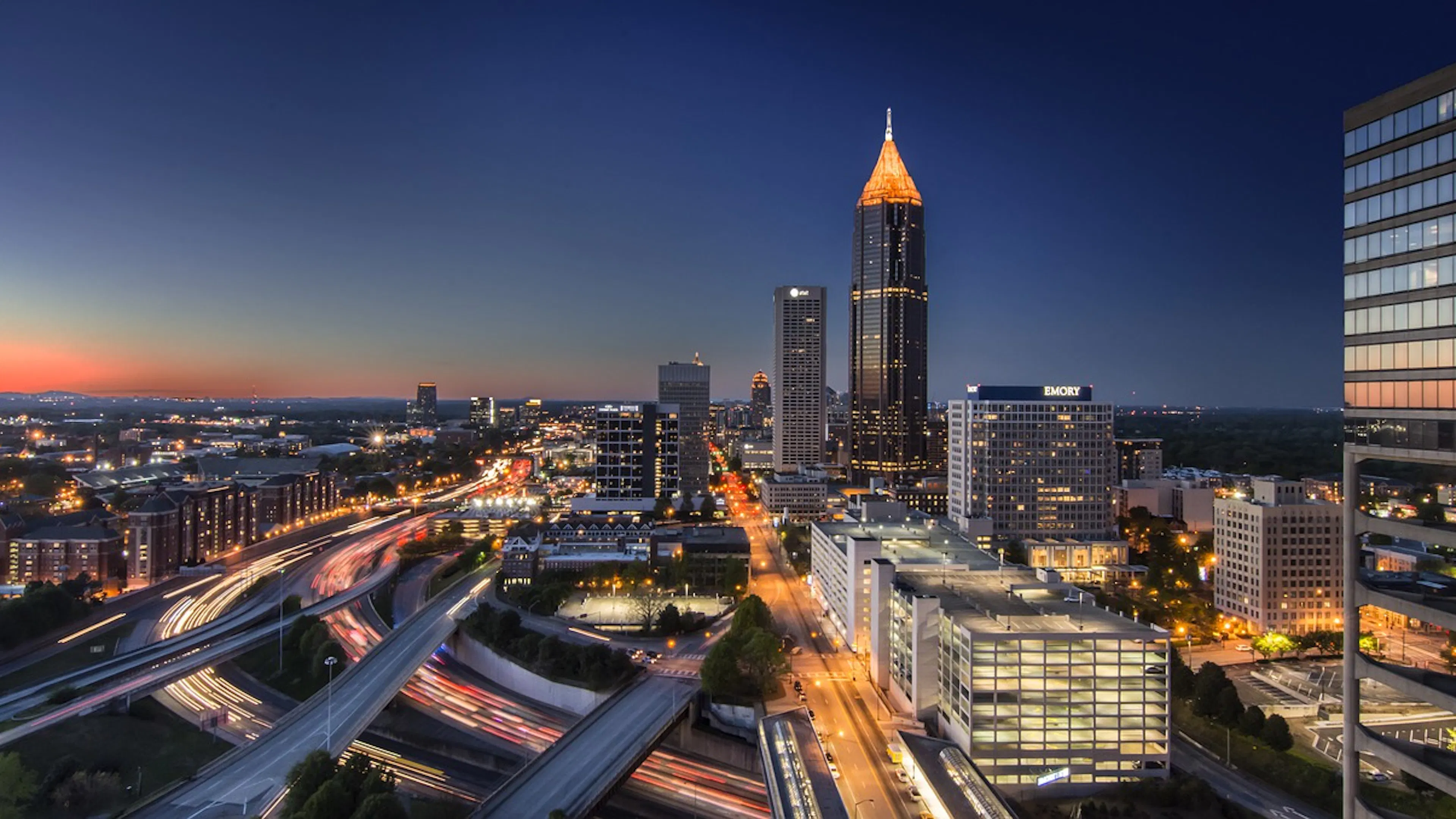 The downtown Atlanta skyline at dusk with just a hit of orange sunlight still in the sky