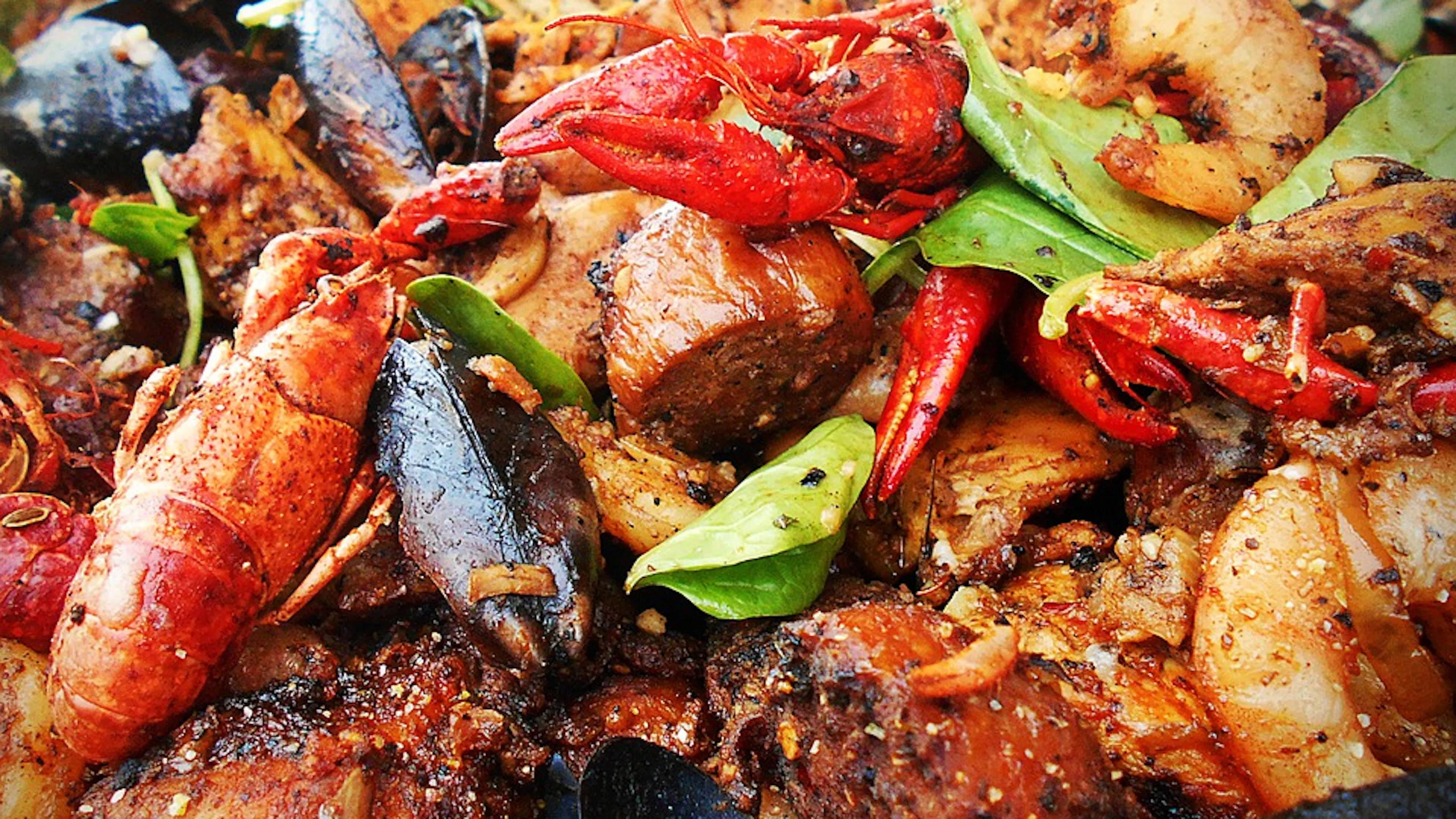 A close up of seafood jambalaya with shrimp mussels and scallops with plenty of spices