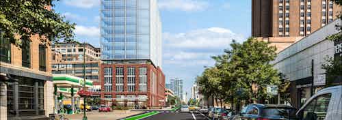 Rendering of AMLI 808 apartment building with red brick on bottom and glass on top and cars and trees lining the street