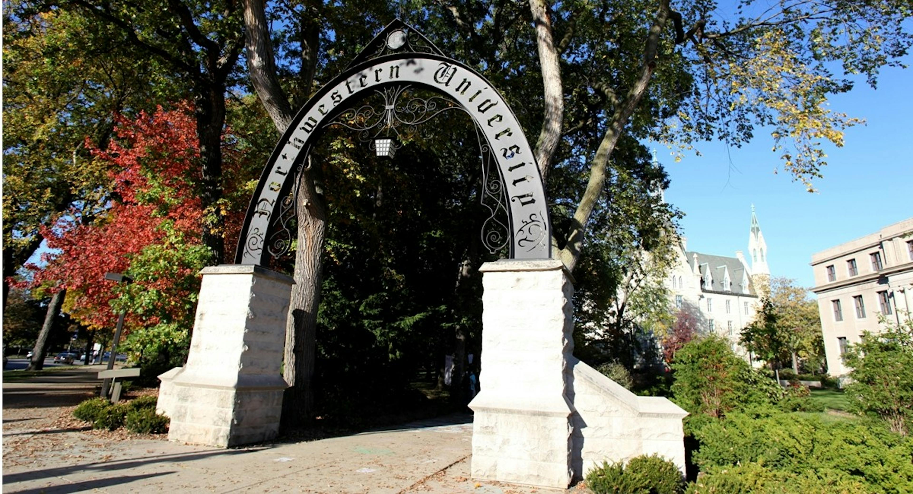 Arch at nearby Northwestern University campus with autumn trees blooming and university buildings visible in the back