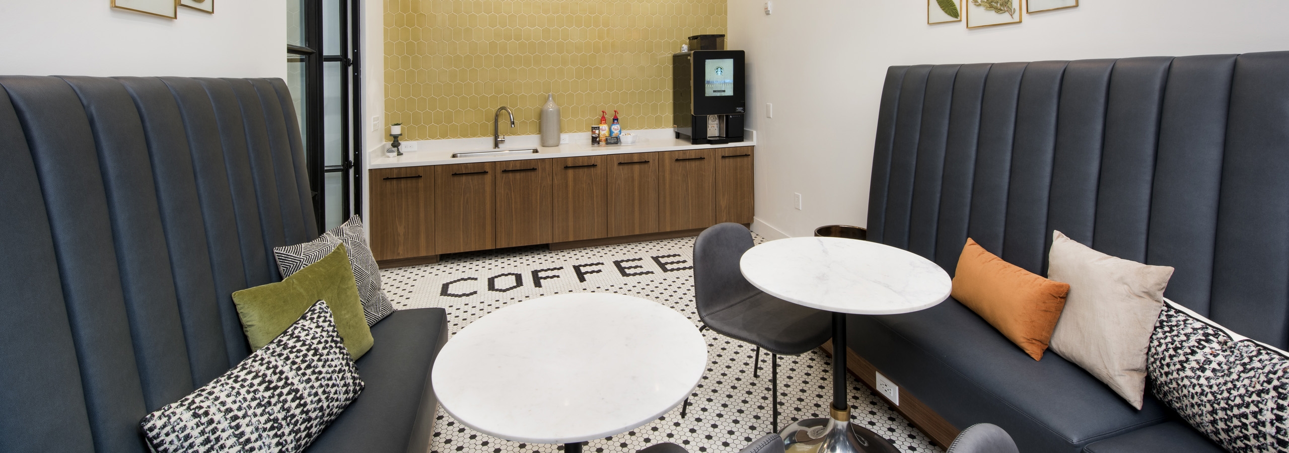 Interior of coffee bar featuring Starbucks coffee at AMLI Decatur apartments with cafe tables and booth seating