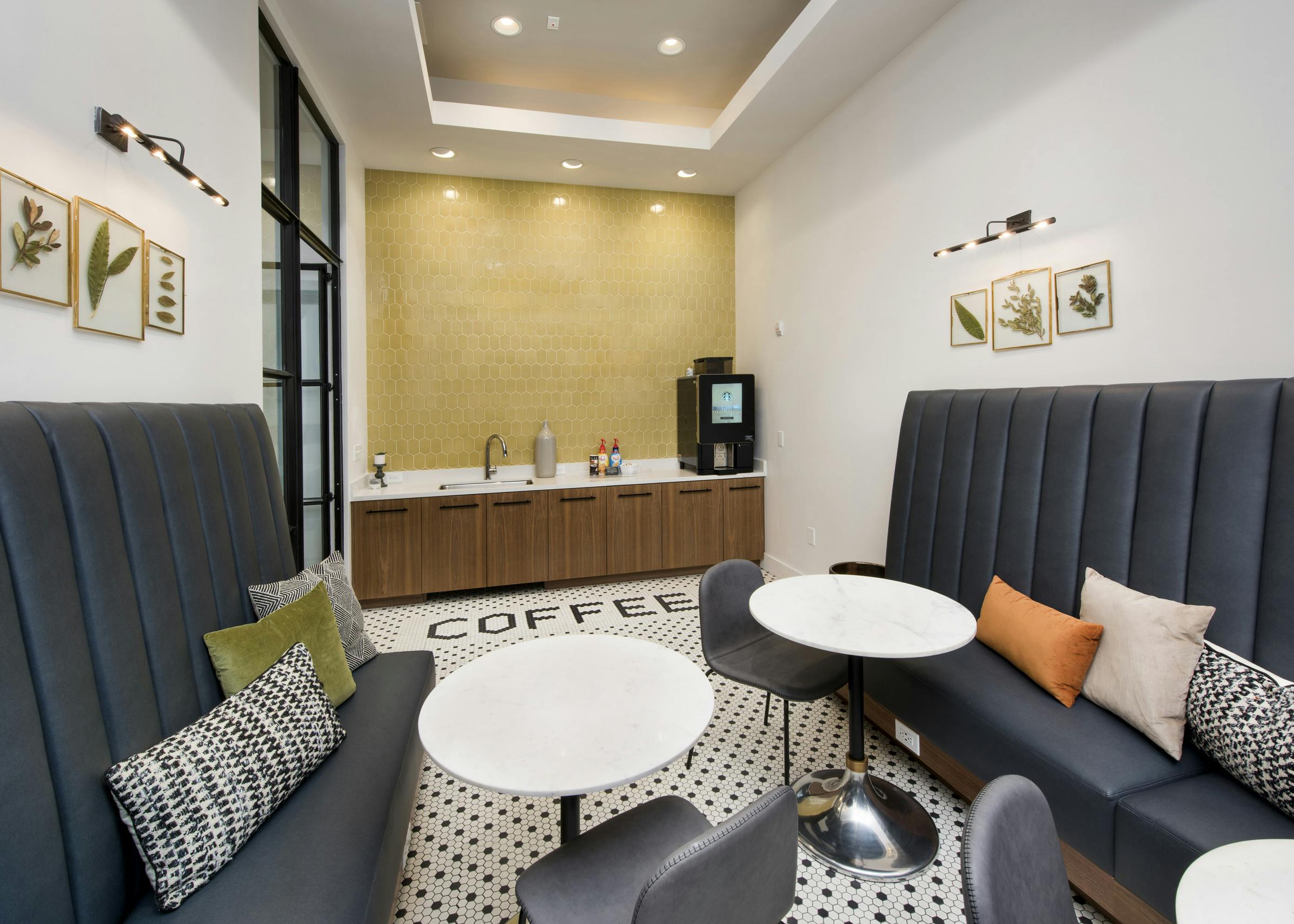 Interior of coffee bar featuring Starbucks coffee at AMLI Decatur apartments with cafe tables and booth seating