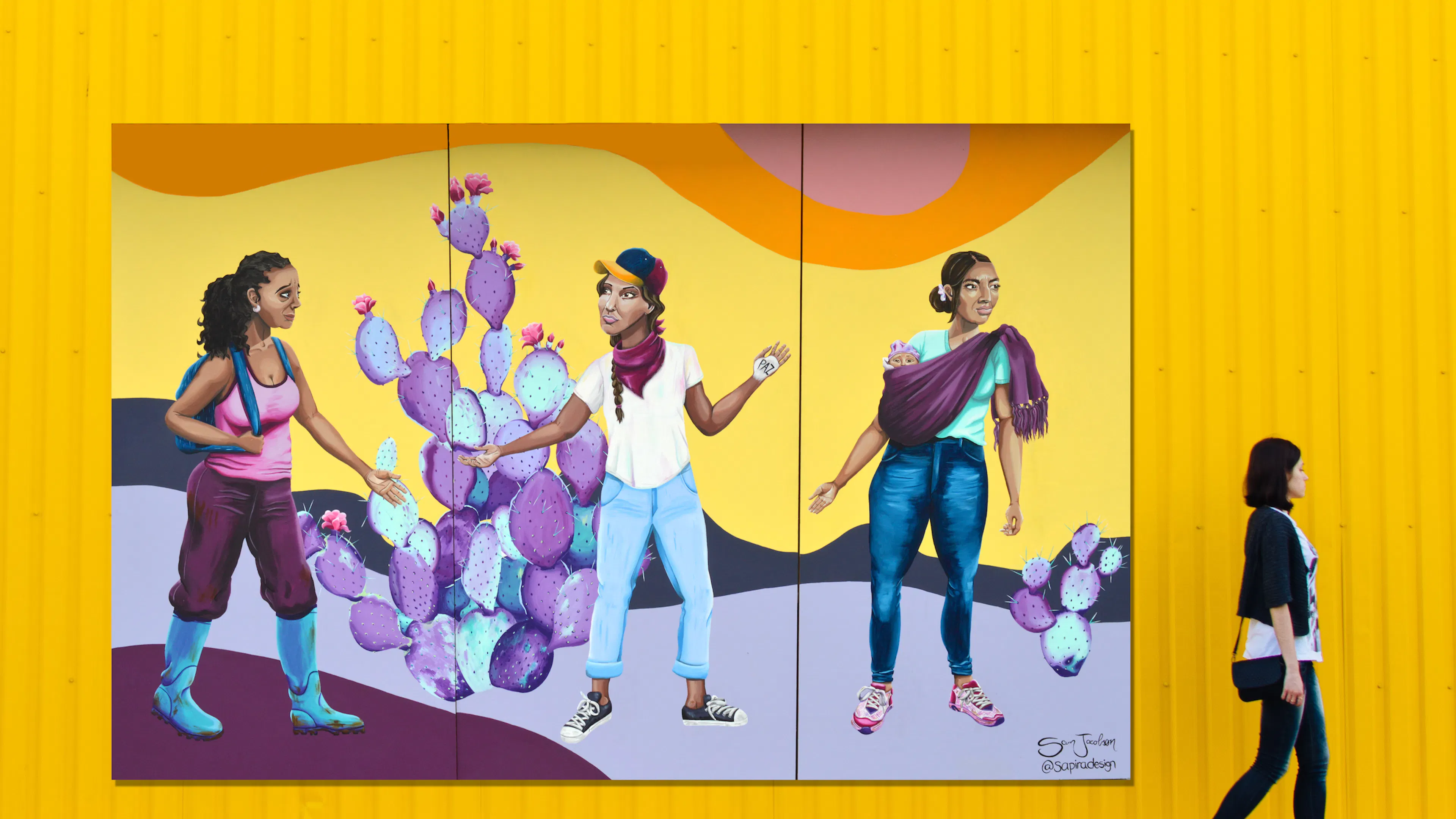 A three-panel mural by Austin artist Sam Jacobson depicting three ladies carrying bags with a bright colorful background