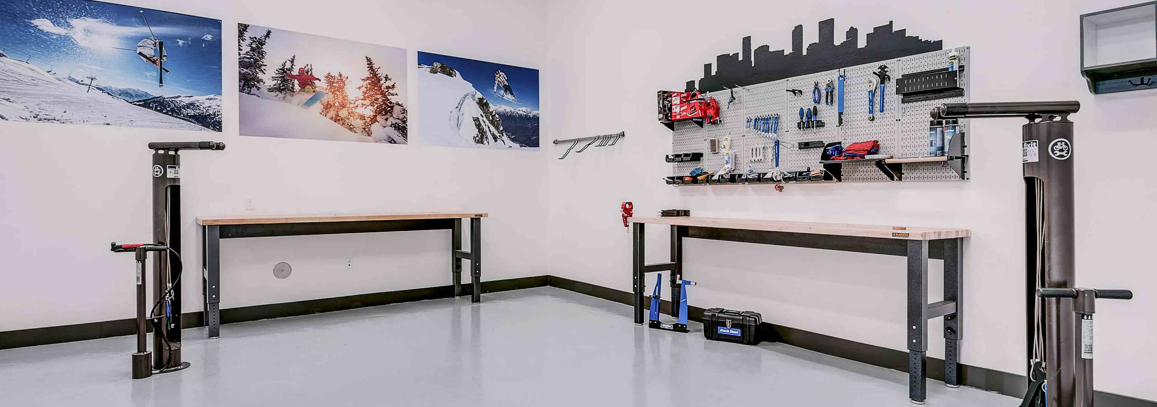 Interior bike repair room area at AMLI Cherry Creek apartments with view of work station table with tools and photography 