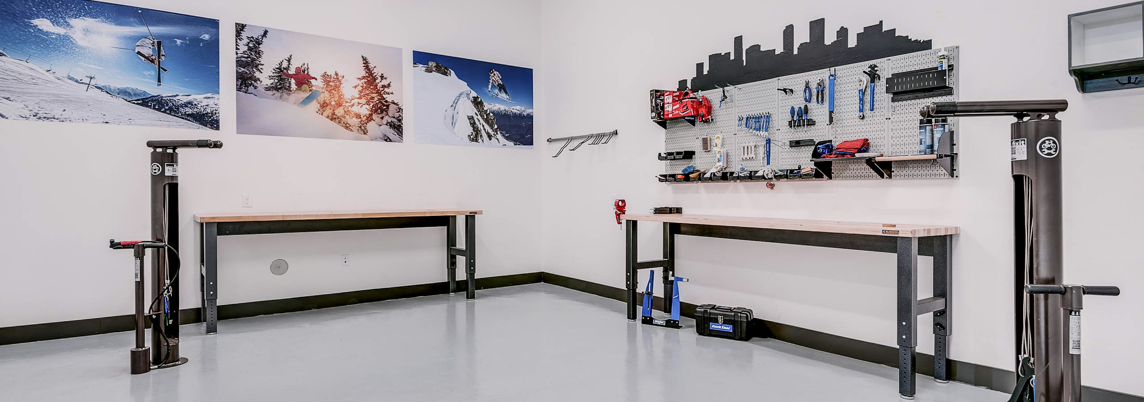 Interior bike repair room area at AMLI Cherry Creek apartments with view of work station table with tools and photography 