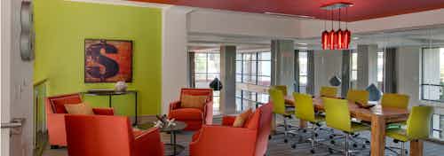 Interior view of AMLI Ponce Park business center with large conference table and smaller lounge chairs for smaller gatherings