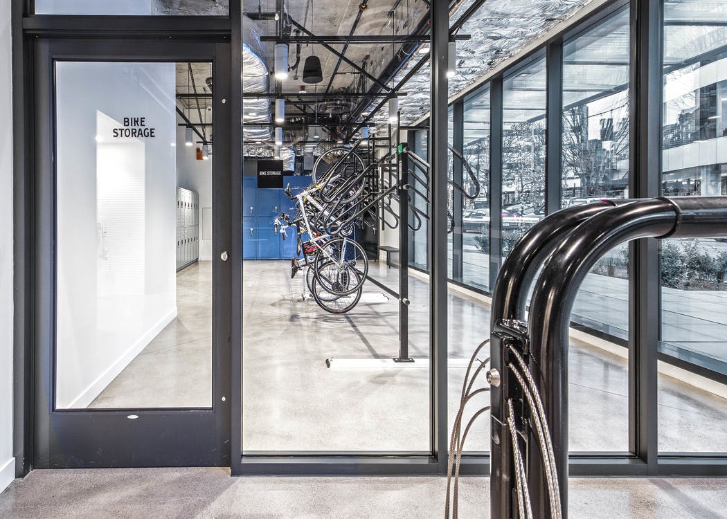 Interior bike lounge with bike storage bike tools bike shower and storage lockers with access to the street at AMLI Arc