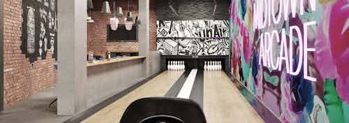 Rendering of the Arcade bowling alley at AMLI Midtown Miami apartments with colorful wall at right and seating at left