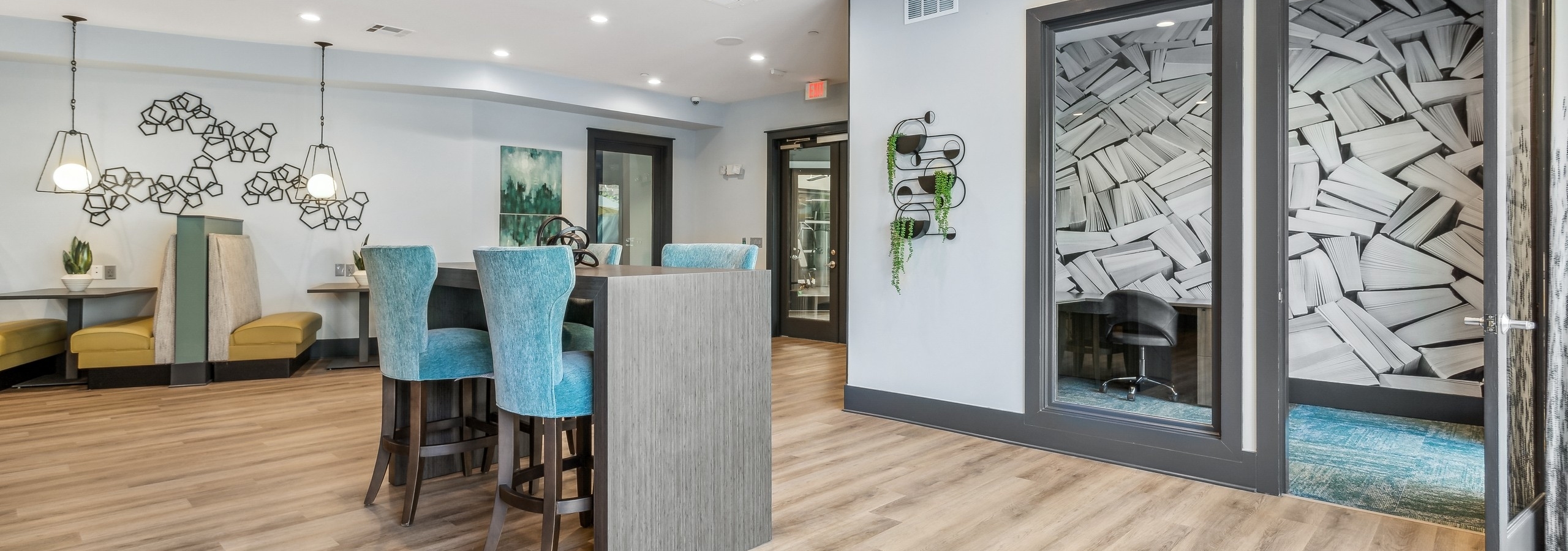 Clubroom and private office at AMLI Parkside apartments with various colorful seating set on light wood floors