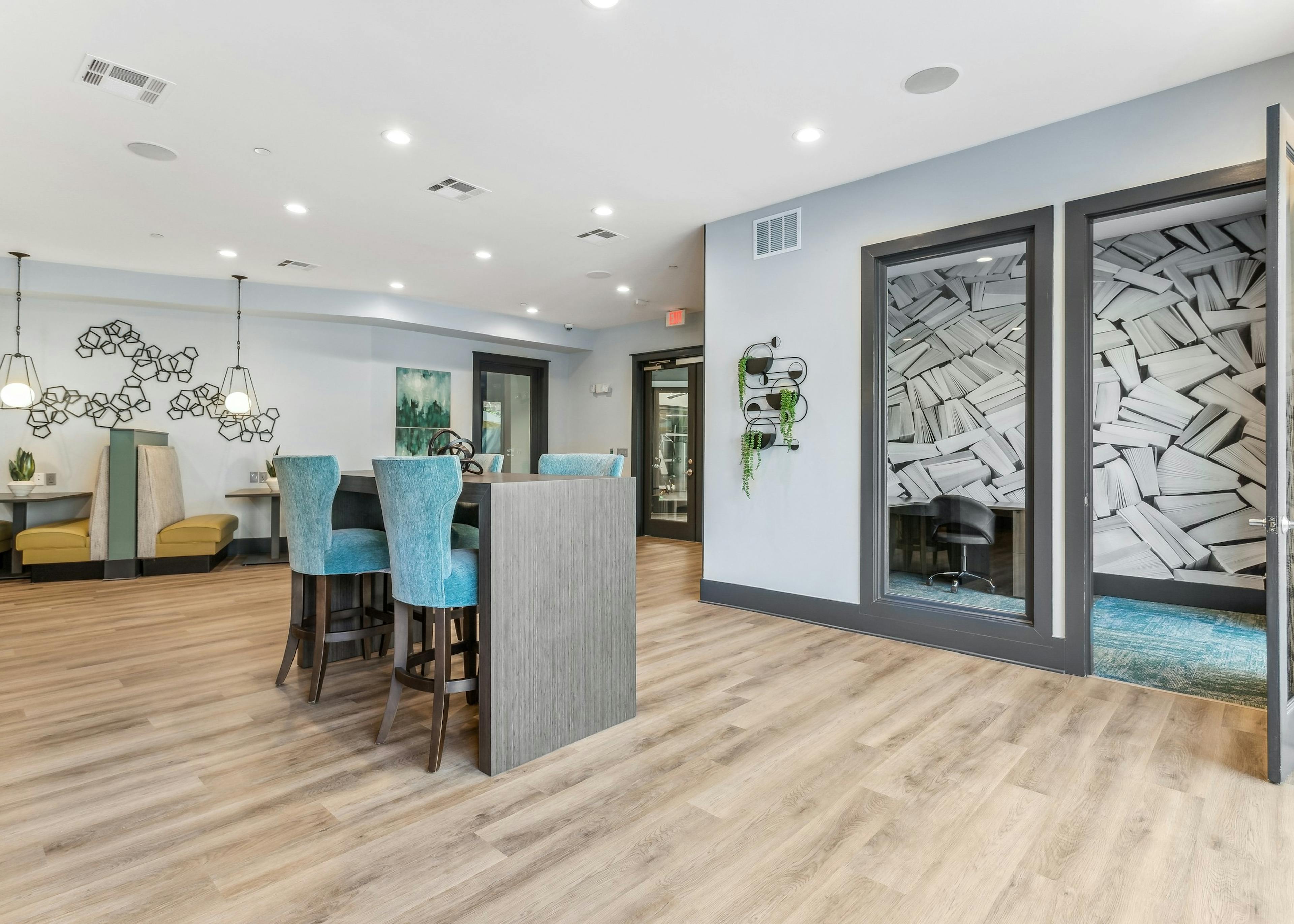 Co-working space and private office at AMLI Parkside apartments with various colorful seating set on light wood floors