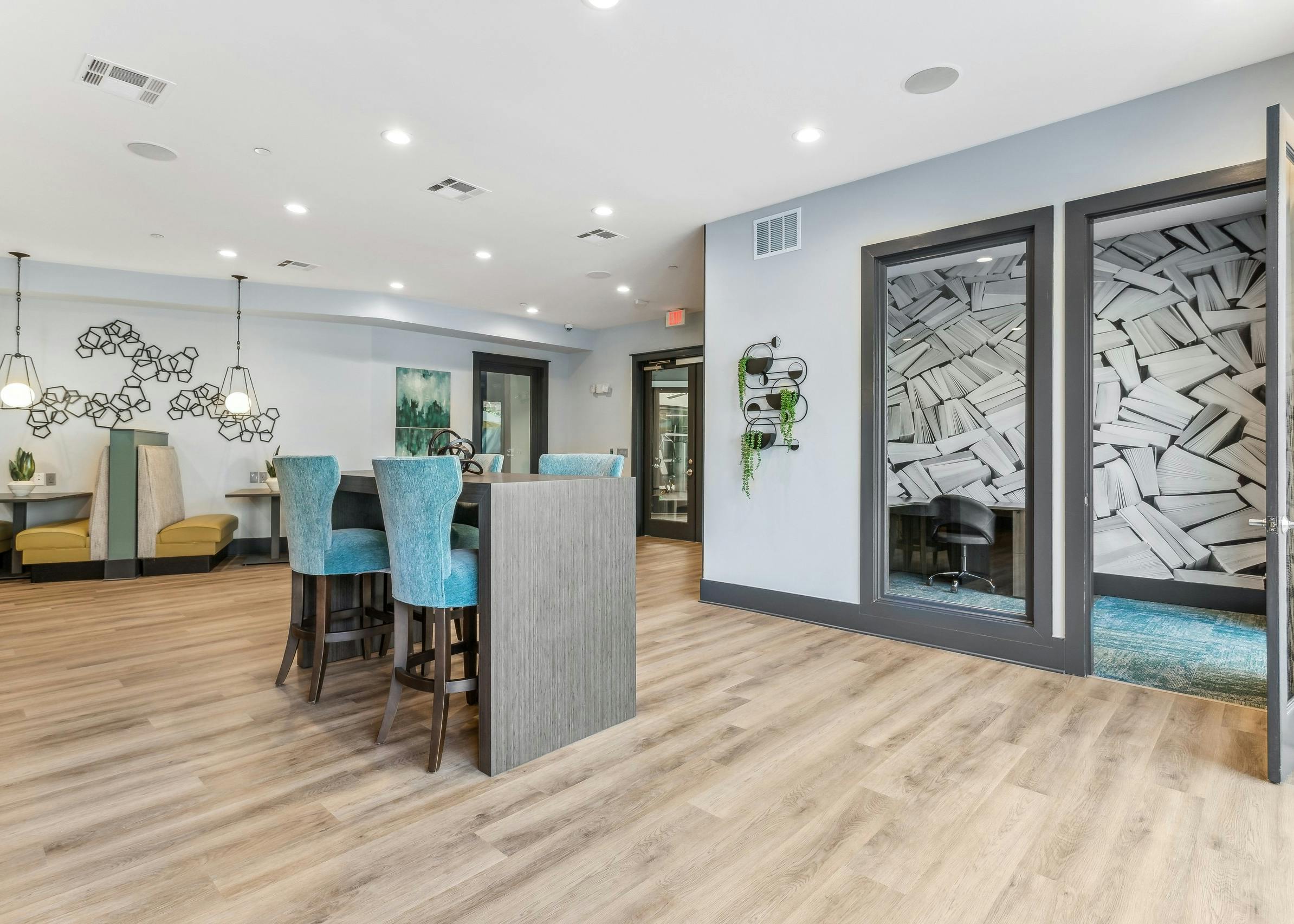 Co-working space and private office at AMLI Parkside apartments with various colorful seating set on light wood floors