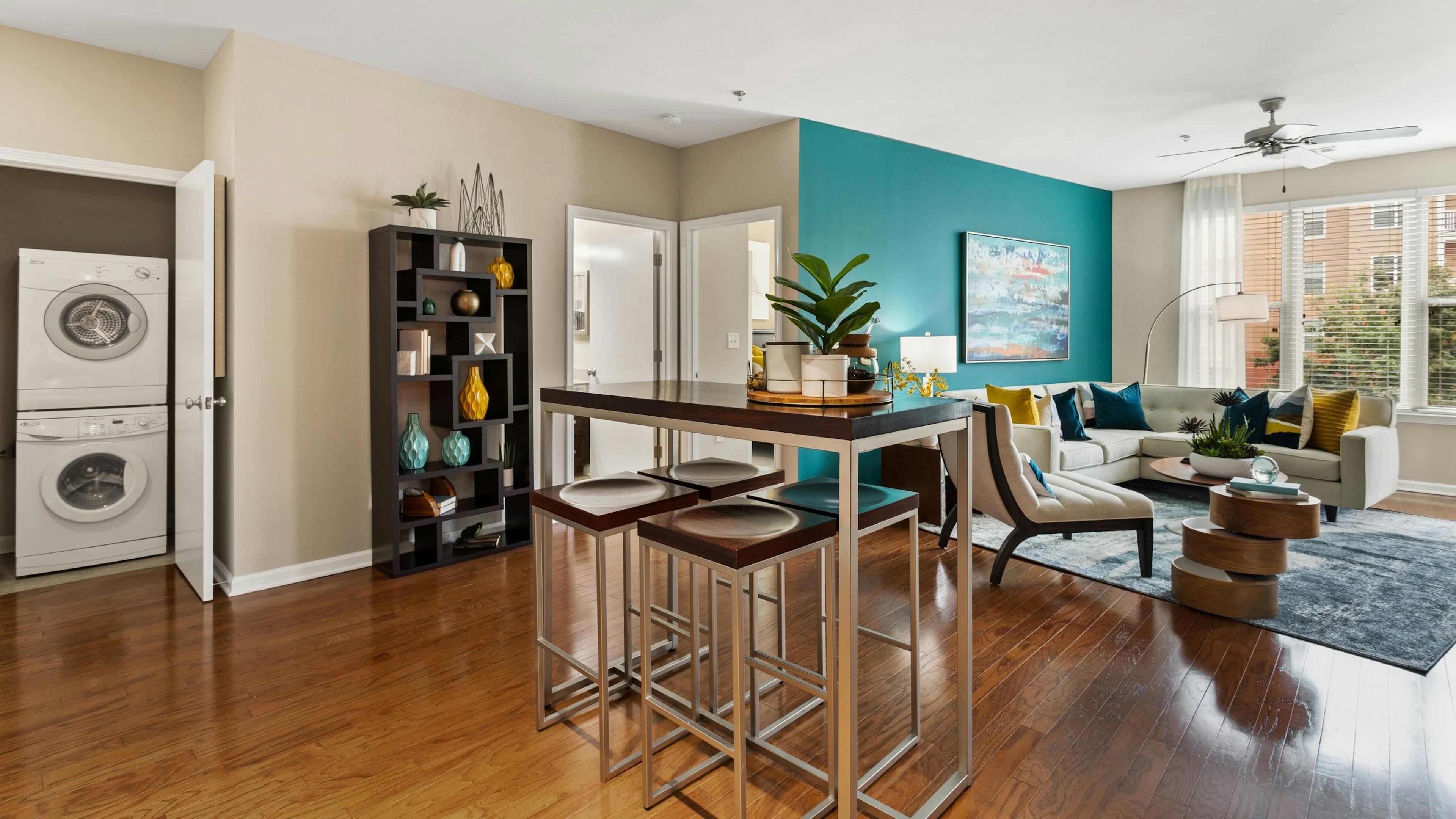 Daytime view of the living room and high top dining table and stacked washer and dryer
at AMLI Lindbergh apartments