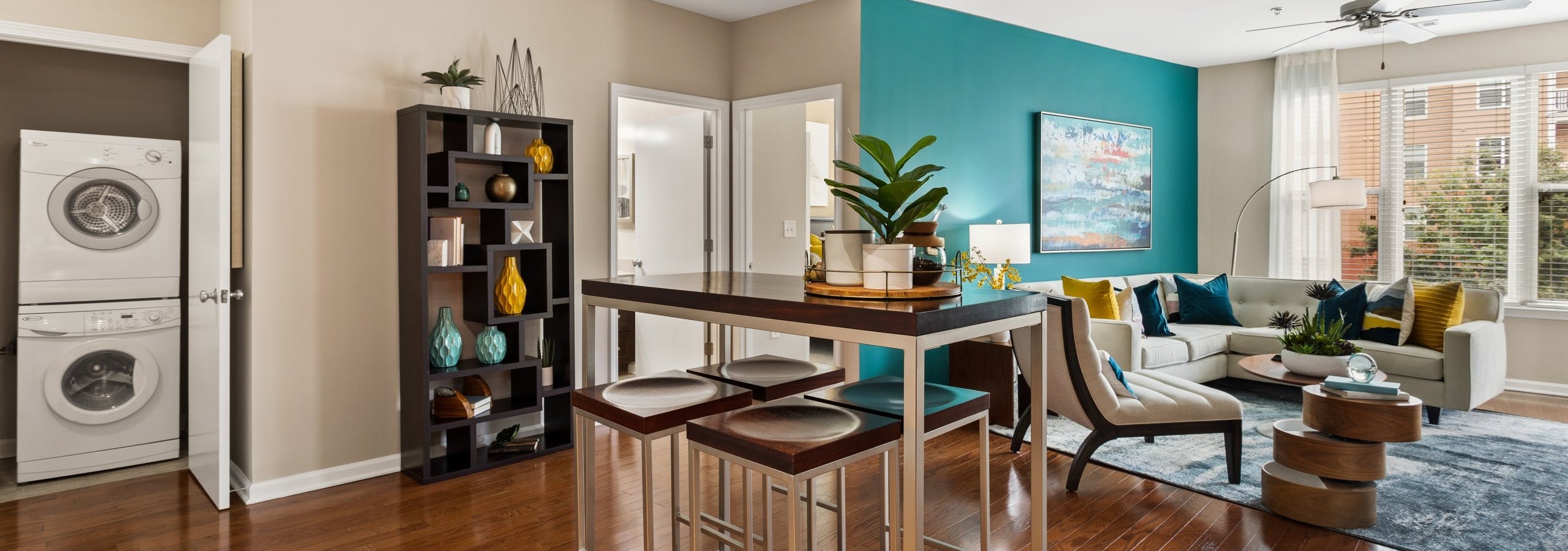 Daytime view of the living room and high top dining table and stacked washer and dryer
at AMLI Lindbergh apartments