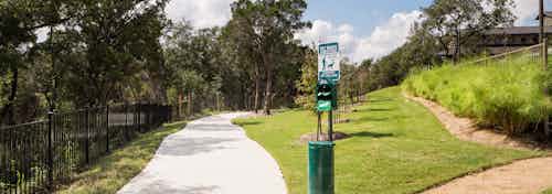 AMLI Covered Bridge’s hiking trail that surrounds the community and provides pet waste eliminator stations