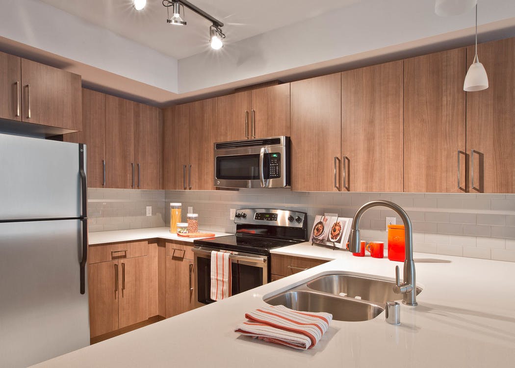 Apartment kitchen at AMLI South Lake Union with light cabinets and white quartz counters and stainless steel appliances
