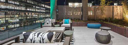 Exterior deck of AMLI Arc with seating and views of Downtown Seattle