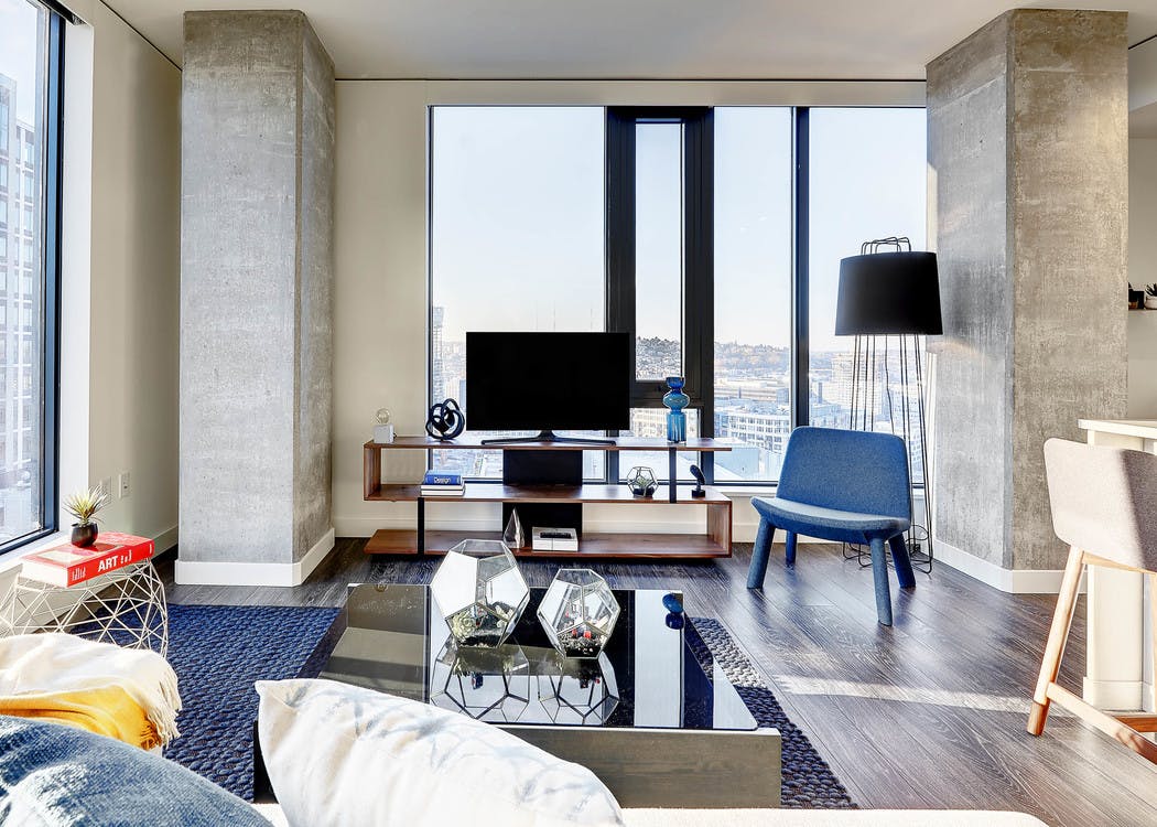 Interior view of apartment of AMLI Arc of living room and window and peek inside bedroom with open door
