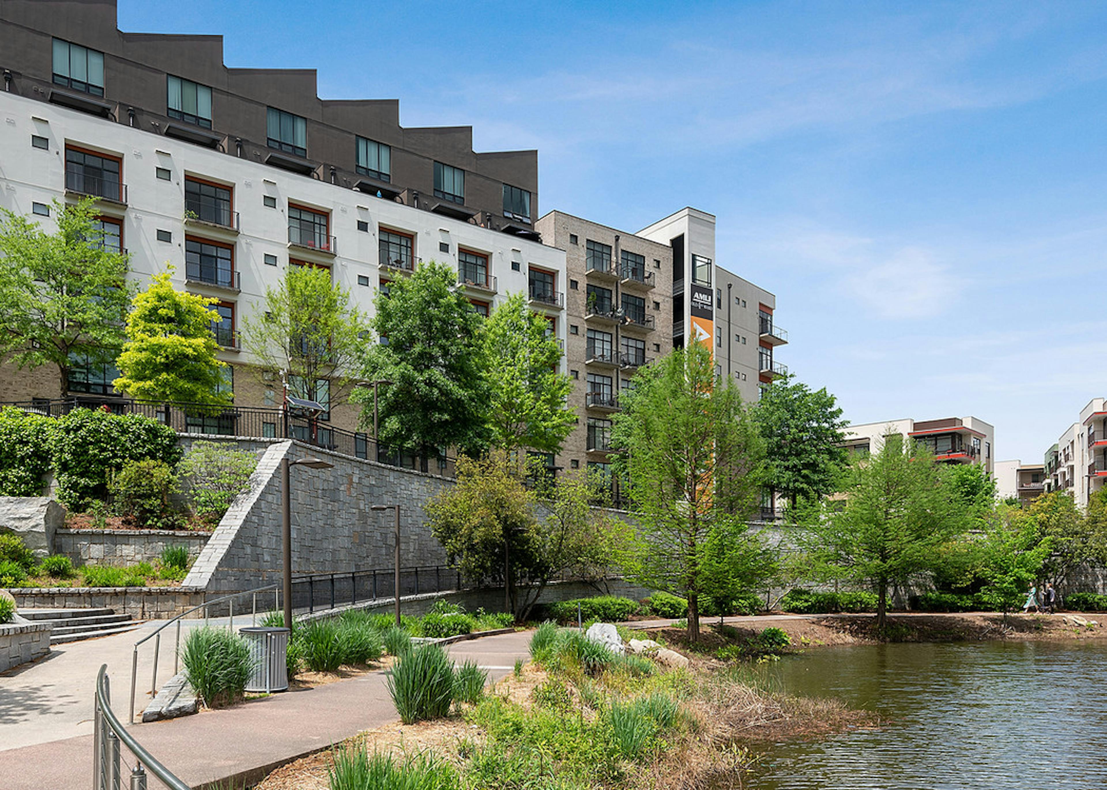 View of AMLI Old 4th Ward just steps away from Historic Old 4th Ward Park with luscious landscaping with walkways and pond
