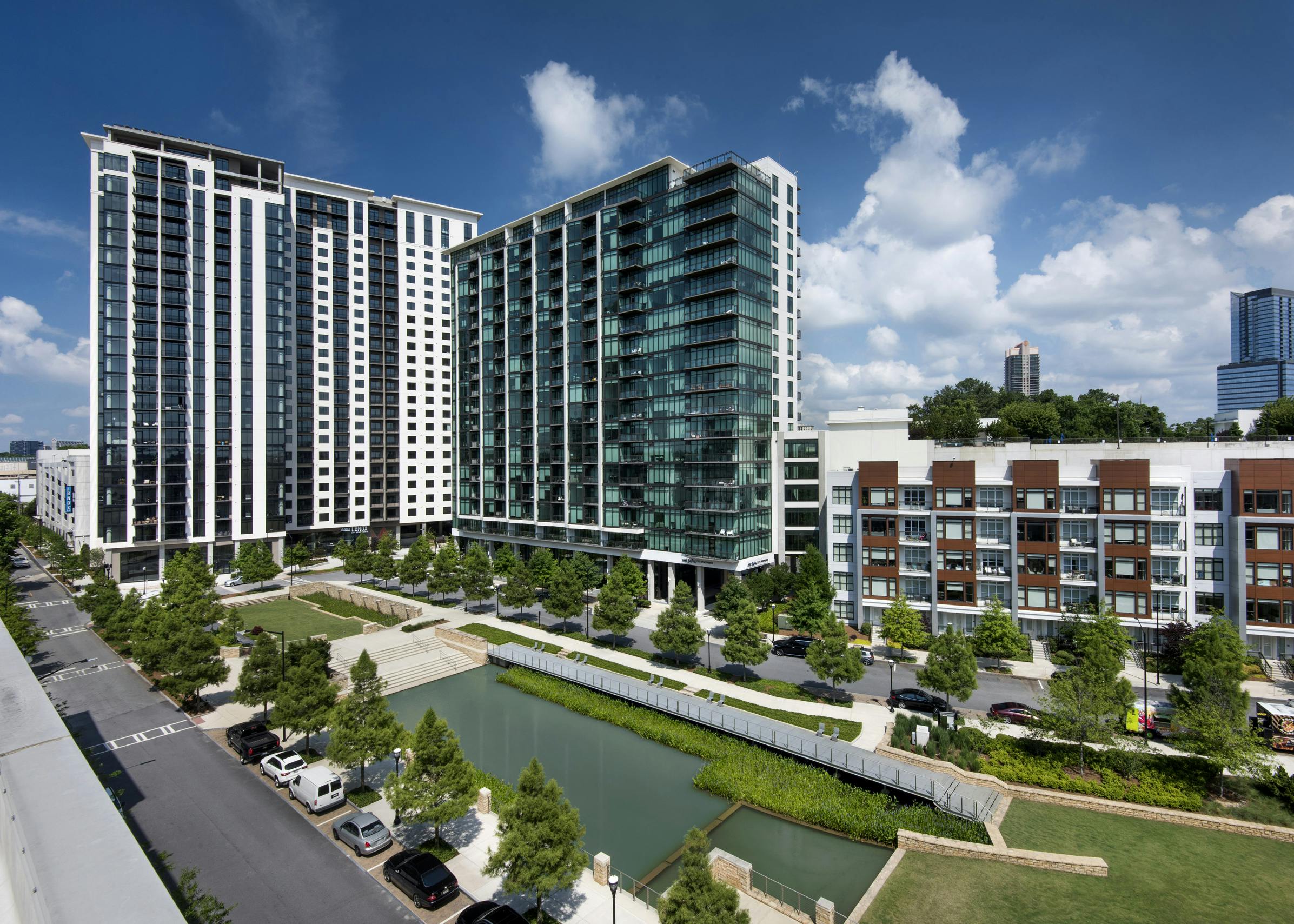 Daytime view of AMLI Lenox apartment building on a  sunny day overlooking Marie Simms Park and a view of AMLI 3464