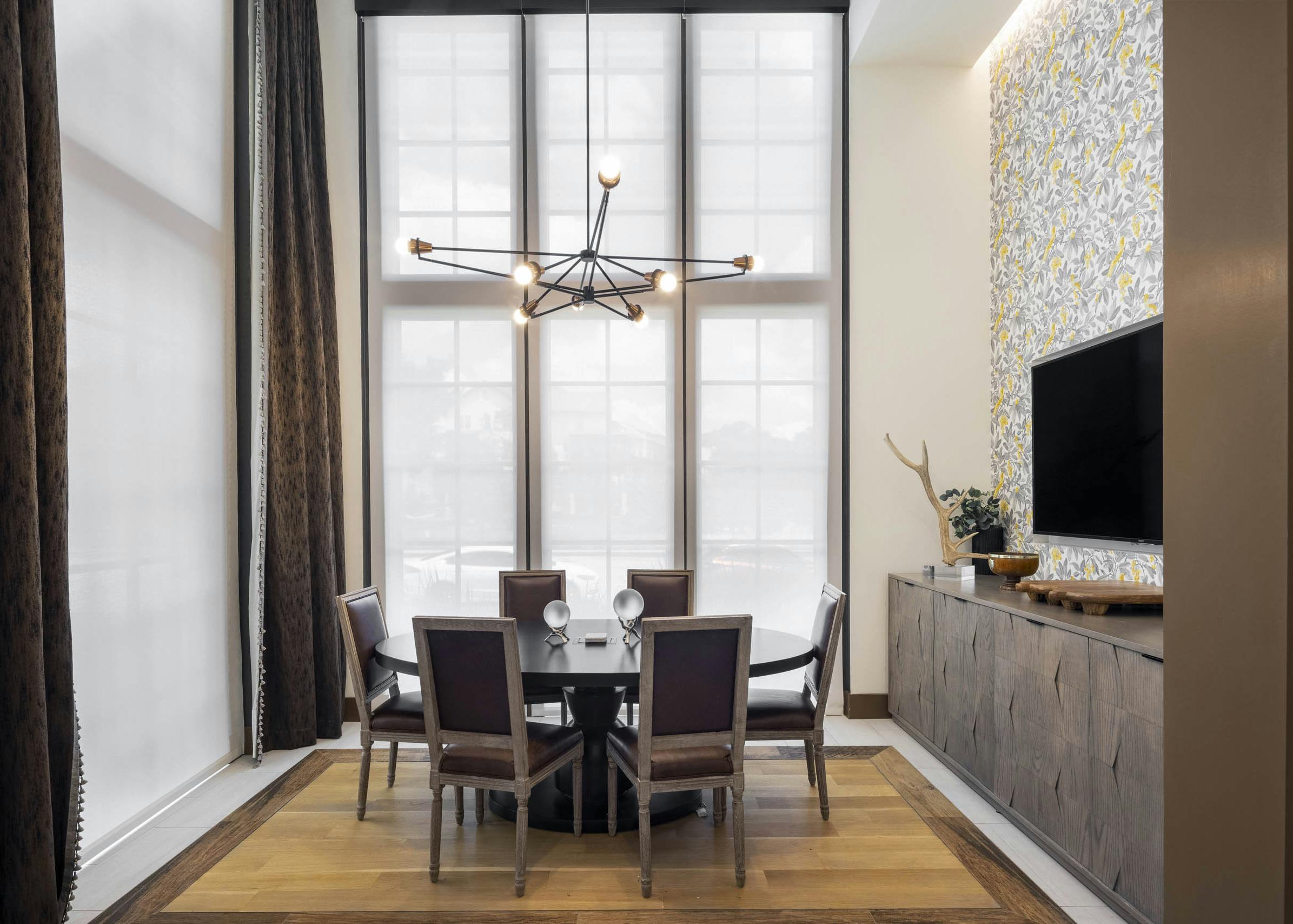 Conference Room at AMLI Lakeline apartments with vaulted ceilings and a wooden oval table surrounded by brown chairs