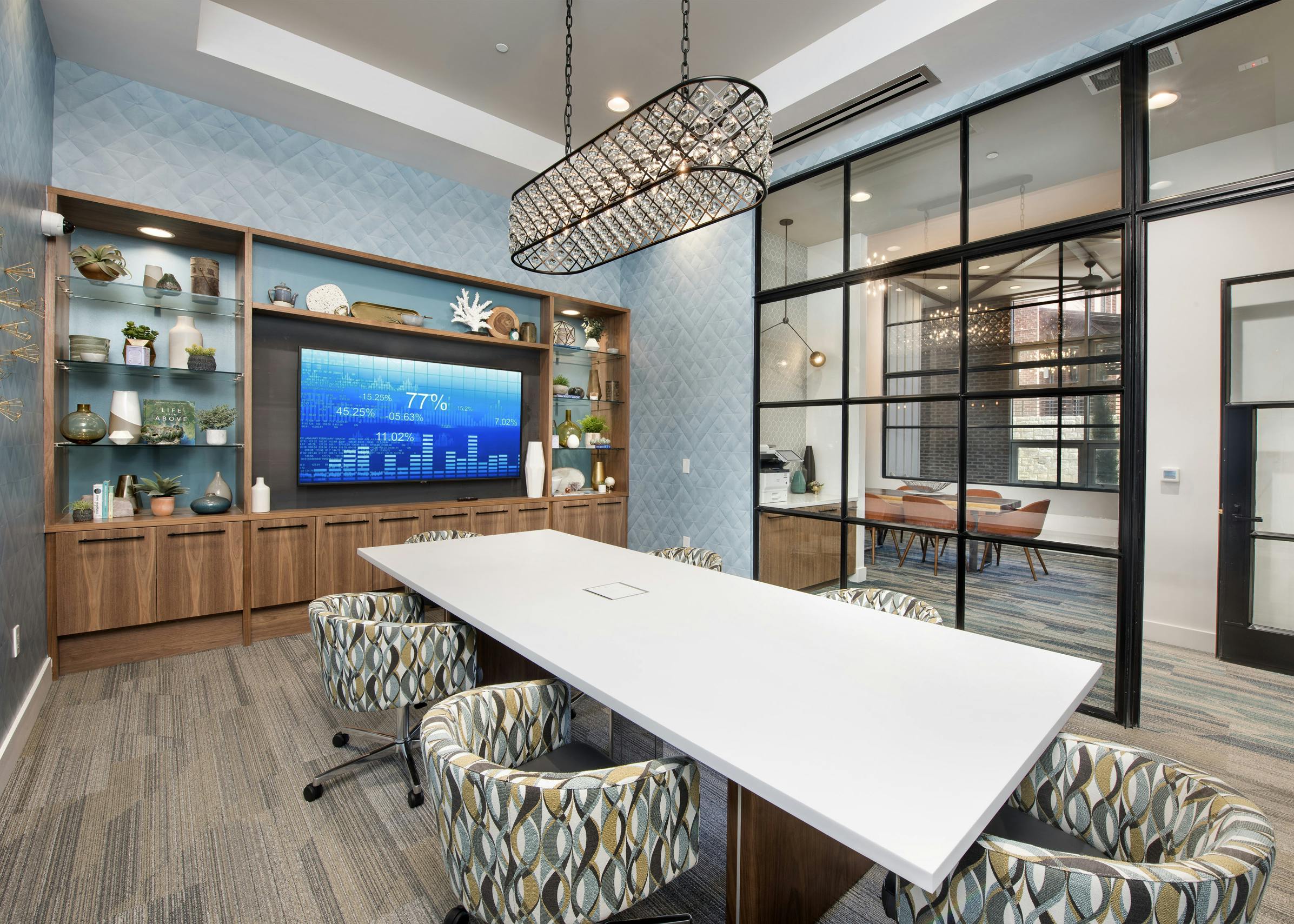 Interior of tech center conference room at AMLI Decatur apartments with big screen TV and long white table and six chairs
