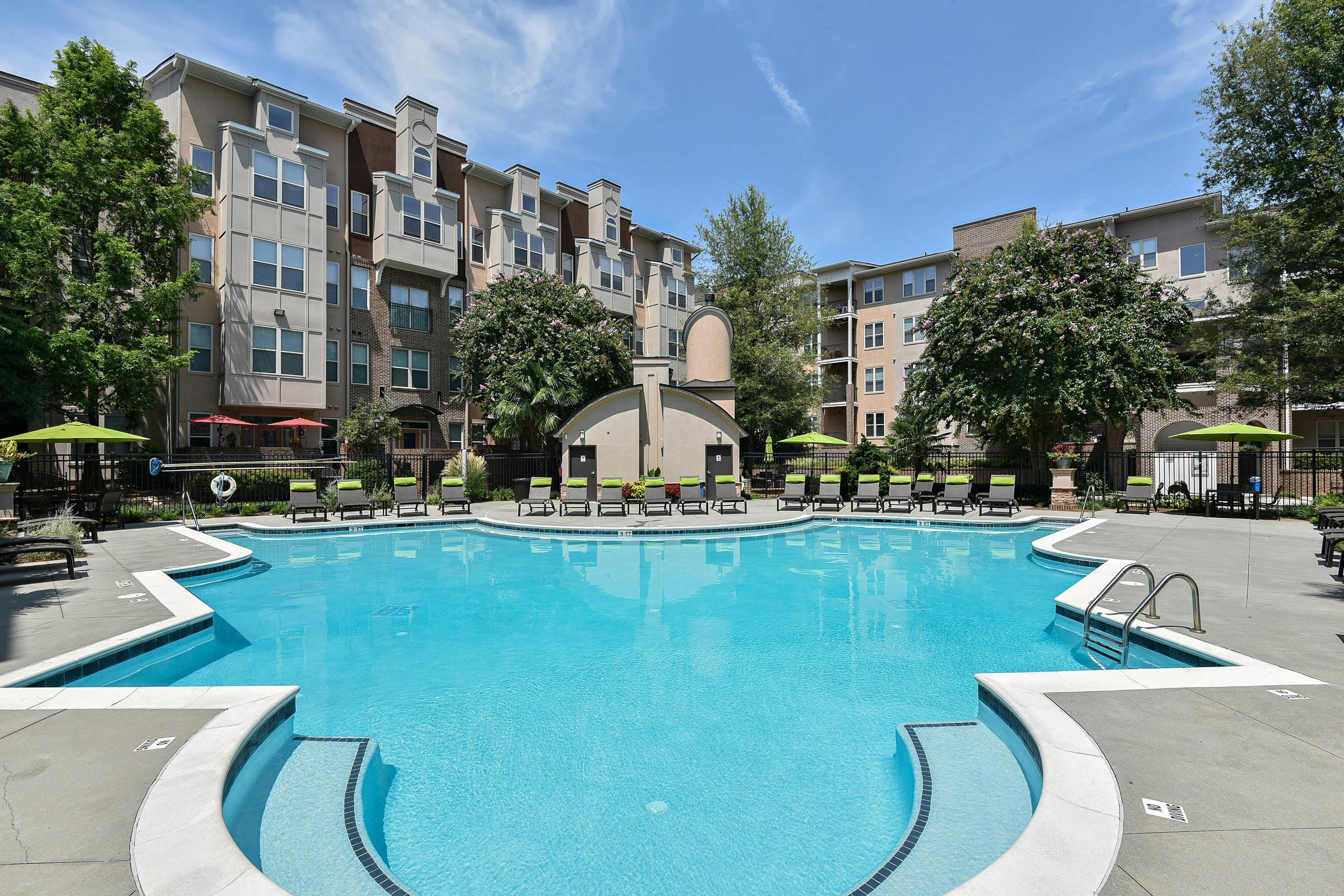 Exterior view of the pool at AMLI Lindbergh during daylight with the apartment community building facade in the background