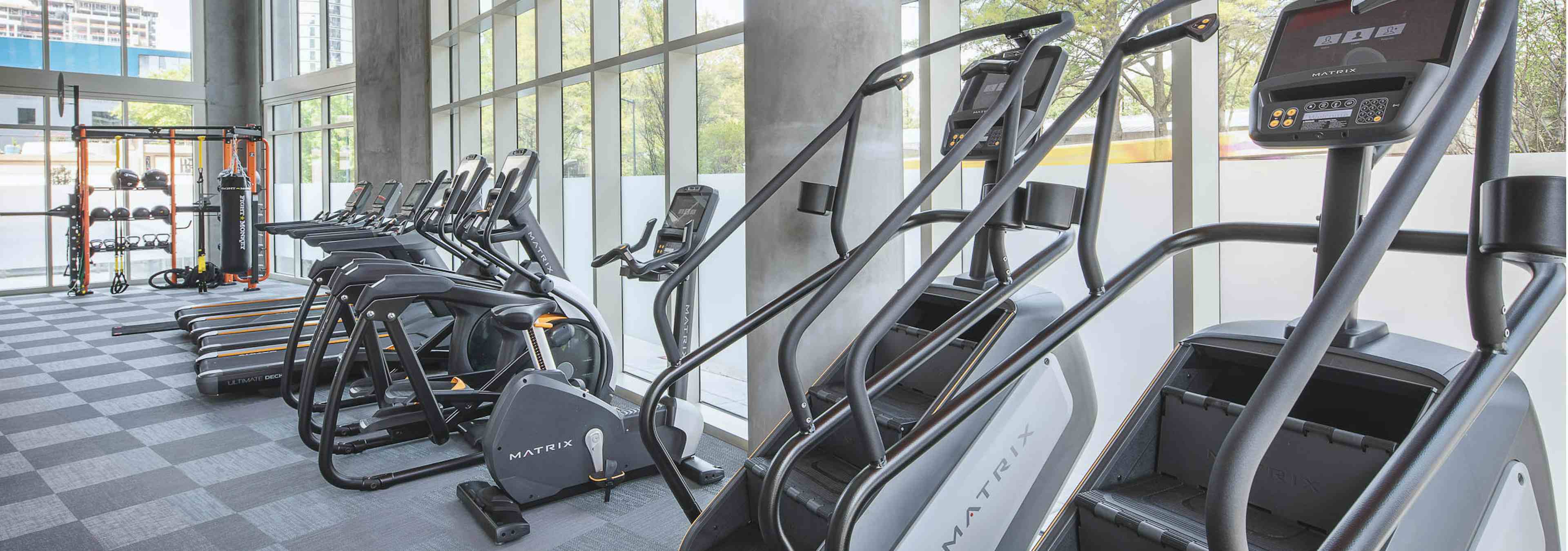 Close up of exercise machines at AMLI Arts Center fitness center including stair climbers, elliptical machines and treadmills