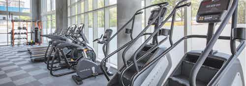 Close up of exercise machines at AMLI Arts Center fitness center including stair climbers, elliptical machines and treadmills
