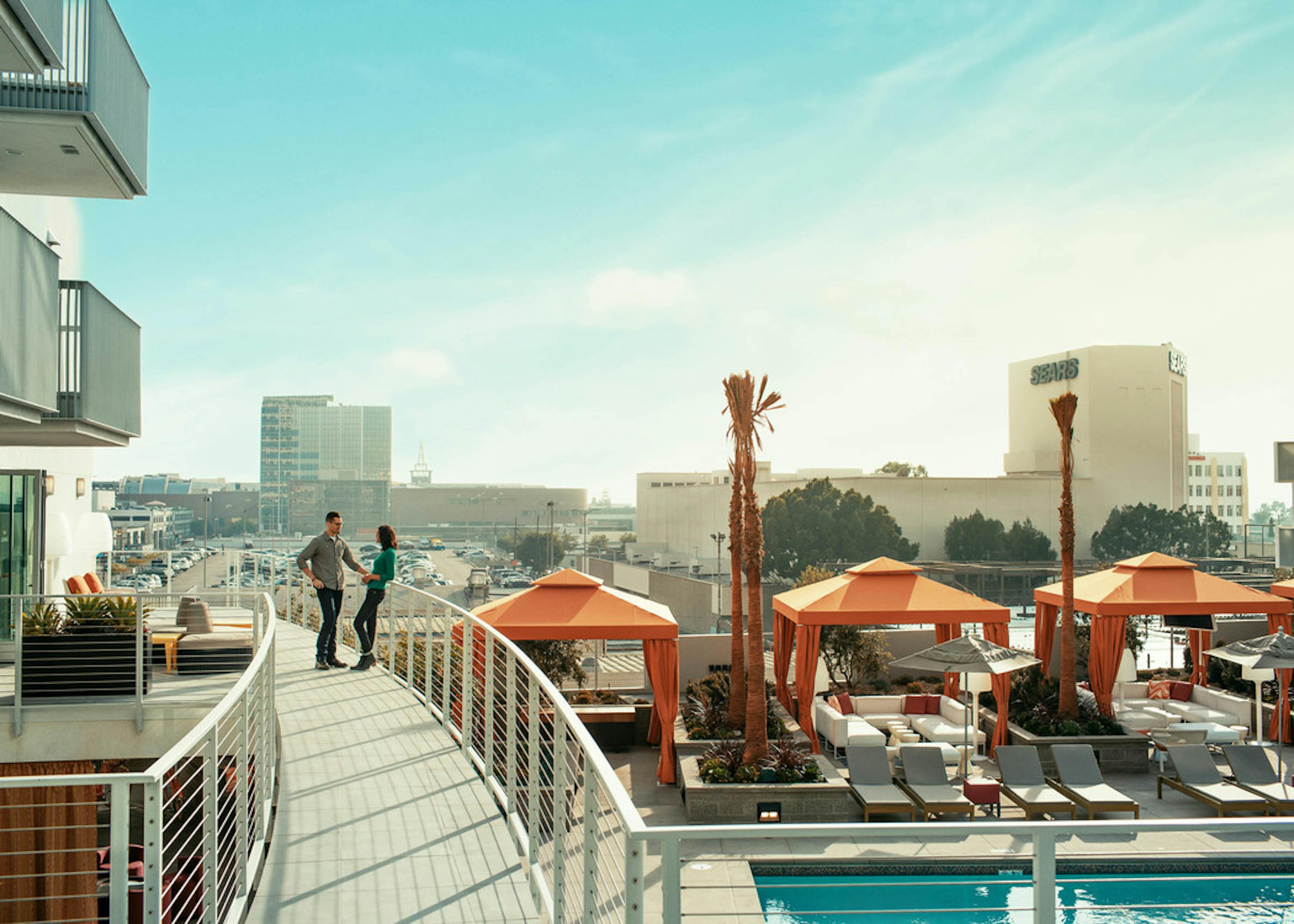 Daytime exterior view of AMLI Lex on Orange apartment building VIP lounge overlooking the city and pool deck with cabanas