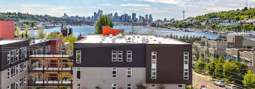 An exterior view of lake union and downtown Seattle from one of 3 rooftop decks at AMLI Wallingford on a beautiful sunny day