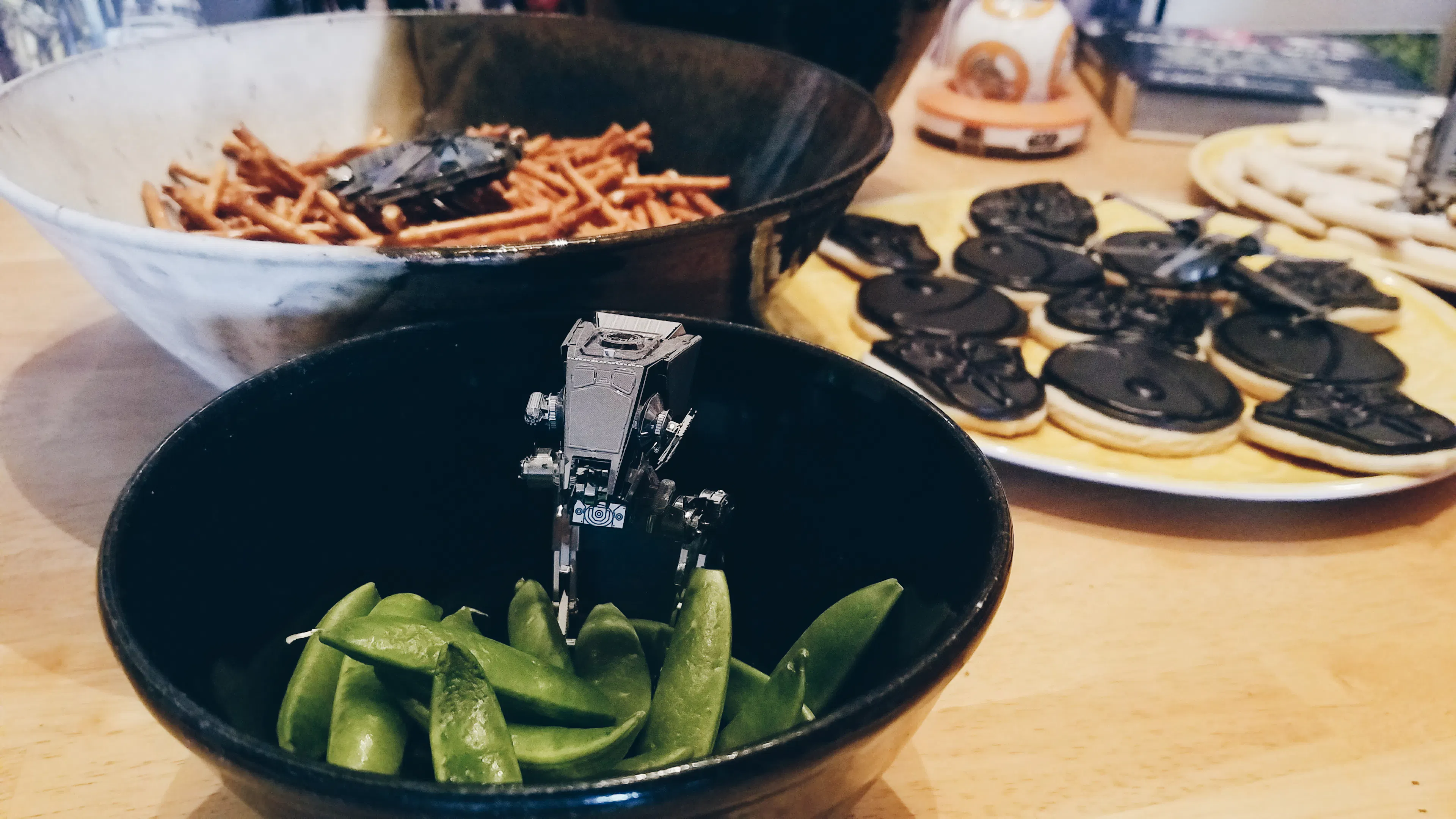 Metal model of a Star Wars vehicle in a bowl of snap peas