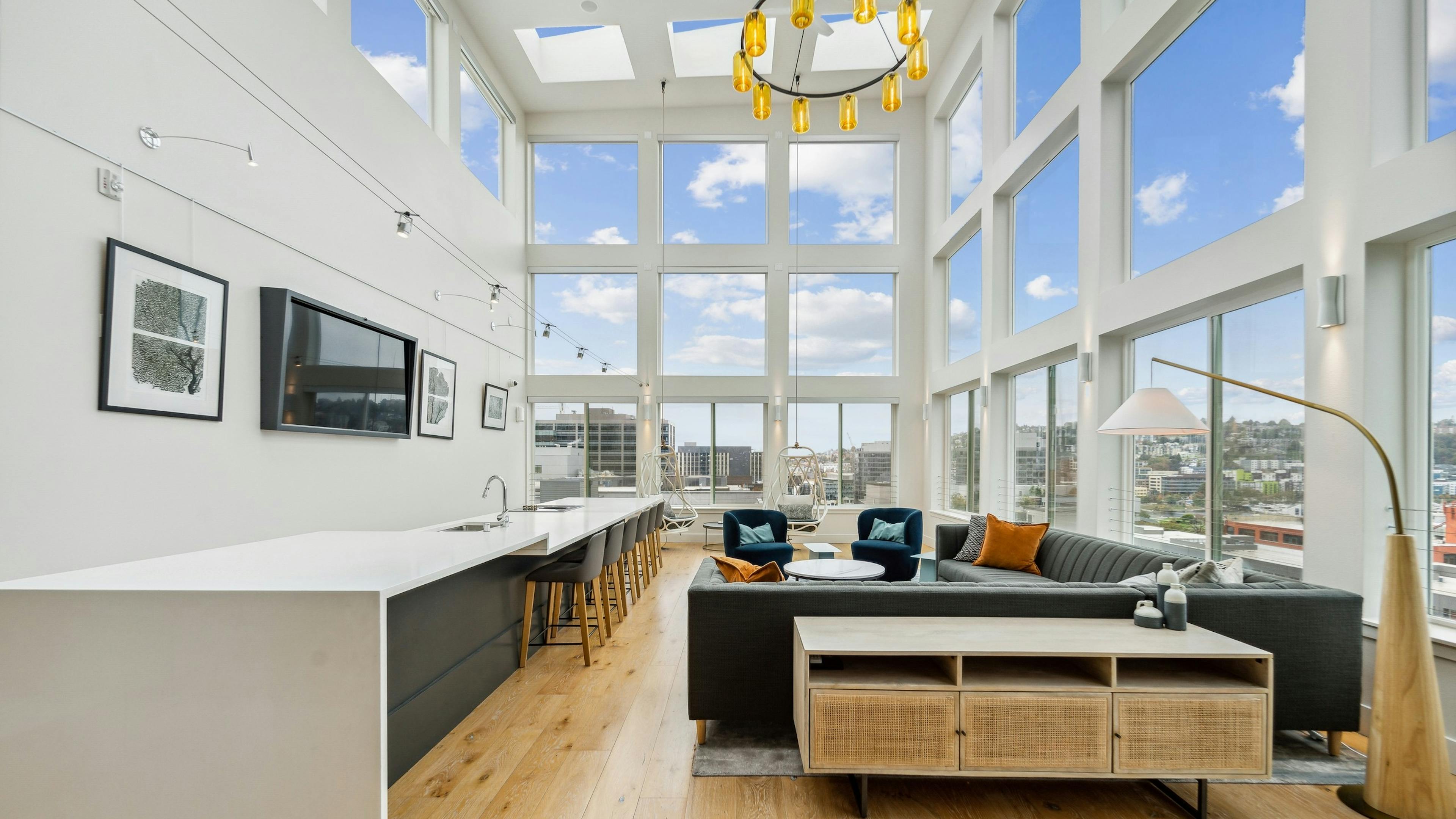 Solarium at AMLI South Lake Union with high ceilings and huge windows with scenic views and seating areas and a long island