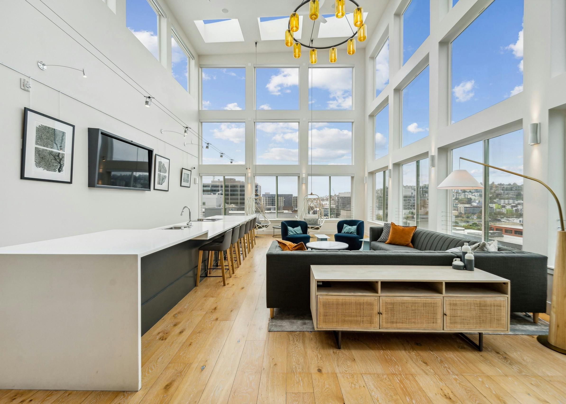 Solarium at AMLI South Lake Union with high ceilings and huge windows with scenic views and seating areas and a long island