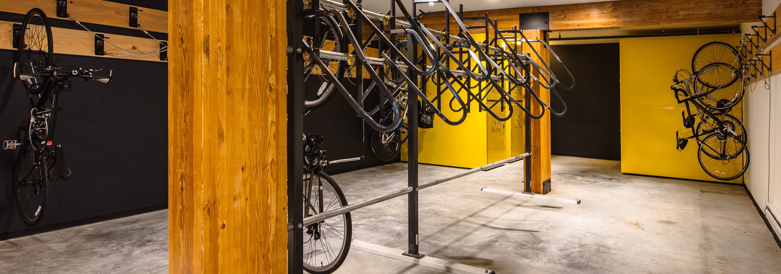 Second bike room at AMLI Wallingford with bike storage tools and yellow and dark blue colorful walls