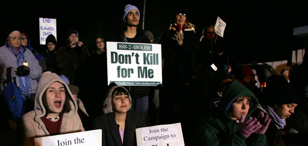 Demonstrators opposed to the death penalty protest the execution of Donald Beardslee at a vigil outside the gates of San Quentin State Prison in San Quentin, California, late January 18, 2004. Beardslee died by lethal injection at 12:01 January 19 at San Quentin Prison for the 1981 murder of 23-year-old Patty Geddling. 