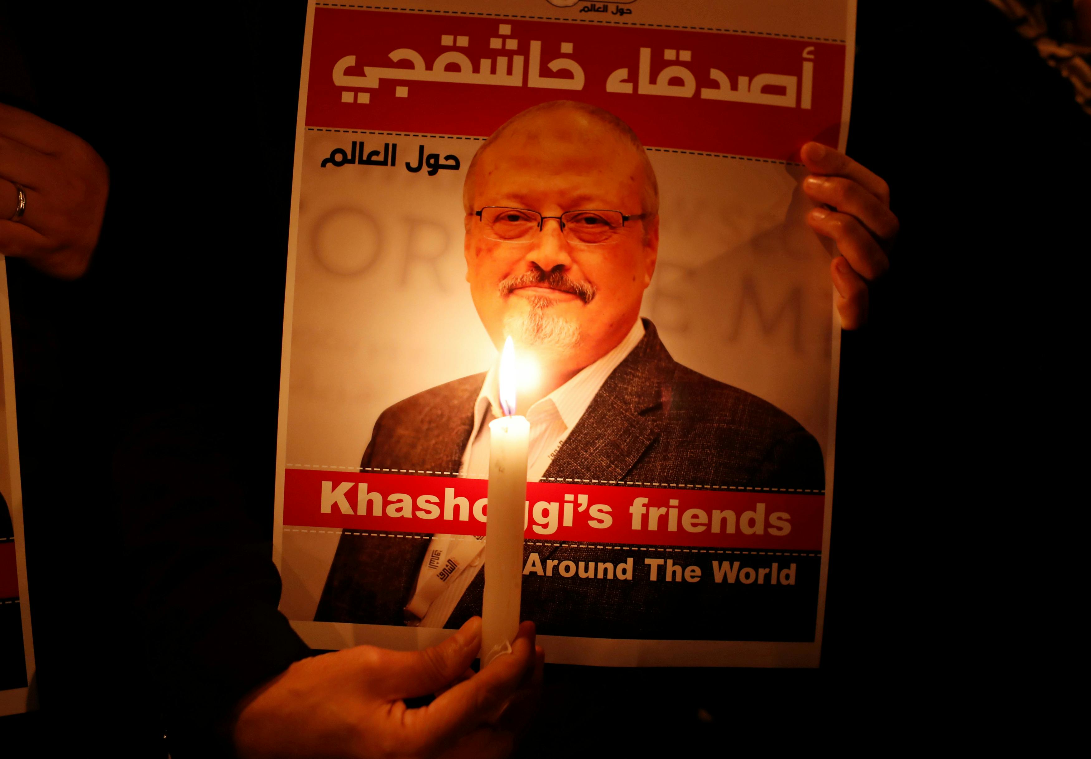 A demonstrator holds a poster with a picture of Saudi journalist Jamal Khashoggi outside the Saudi Arabia consulate in Istanbul