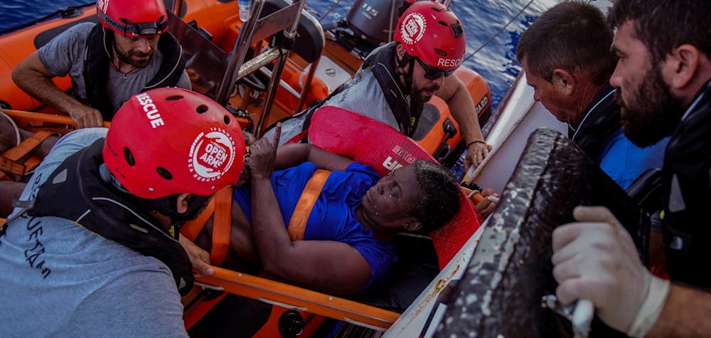 NBA Memphis player Marc Gasol and members of NGO Proactiva Open Arms rescue boat carry Josepha from Cameroon in central Mediterranean Sea, July 17, 2018. Josepha was brought aboard in a state of deep shock and treated by doctors. She told the doctors she had spent the previous night clinging to the wreckage, singing hymns and calling on God for deliverance. 